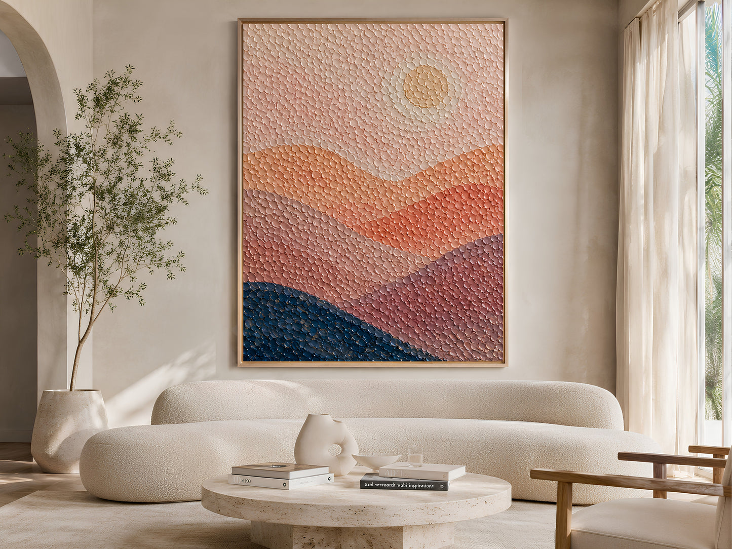 Abstract sunset pointillist print above a curved linen sofa in a bright minimalist living room with olive tree and warm neutral decor
