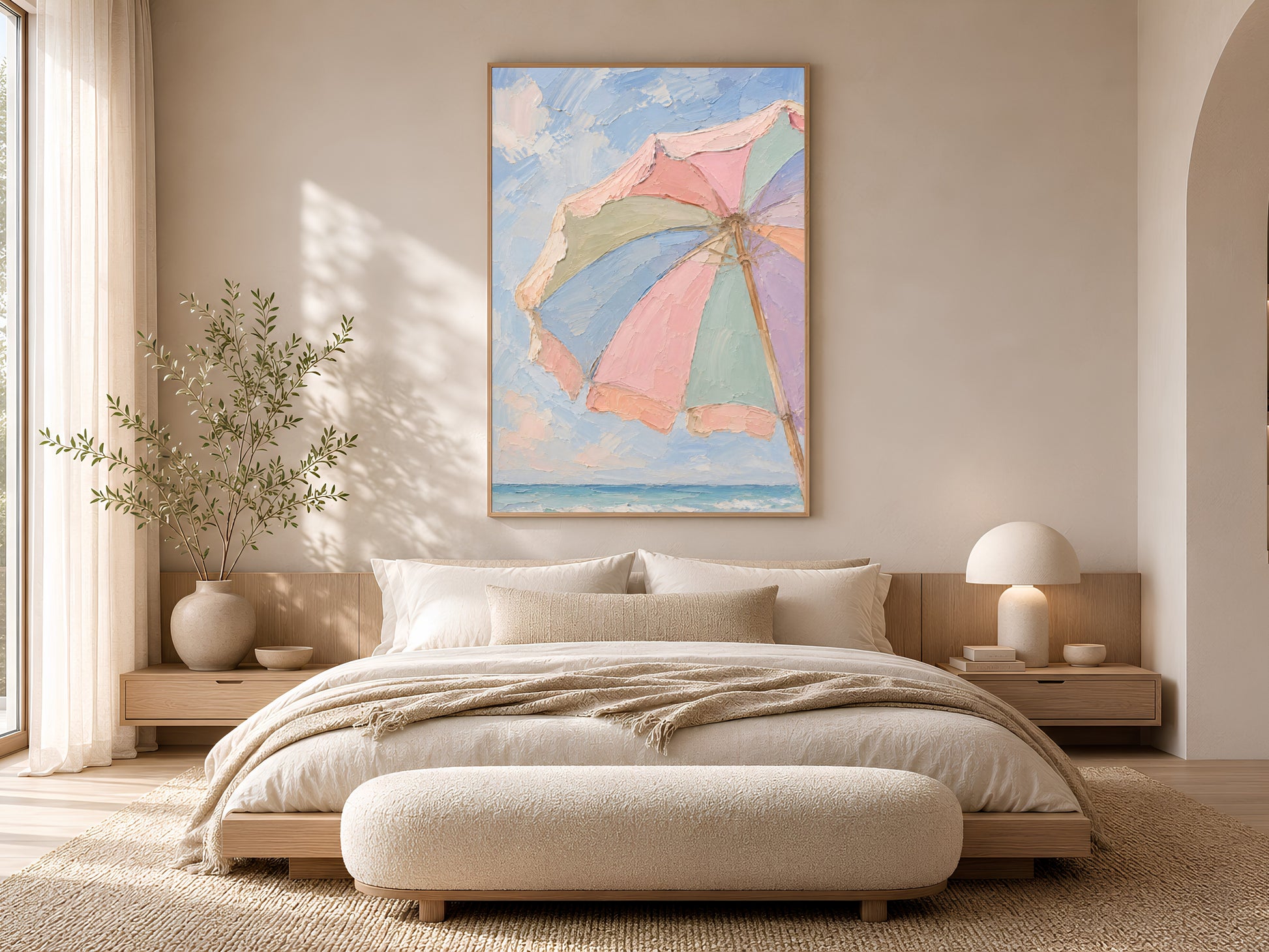 Beach umbrella print framed in gold above a neutral bed in soft coastal bedroom
