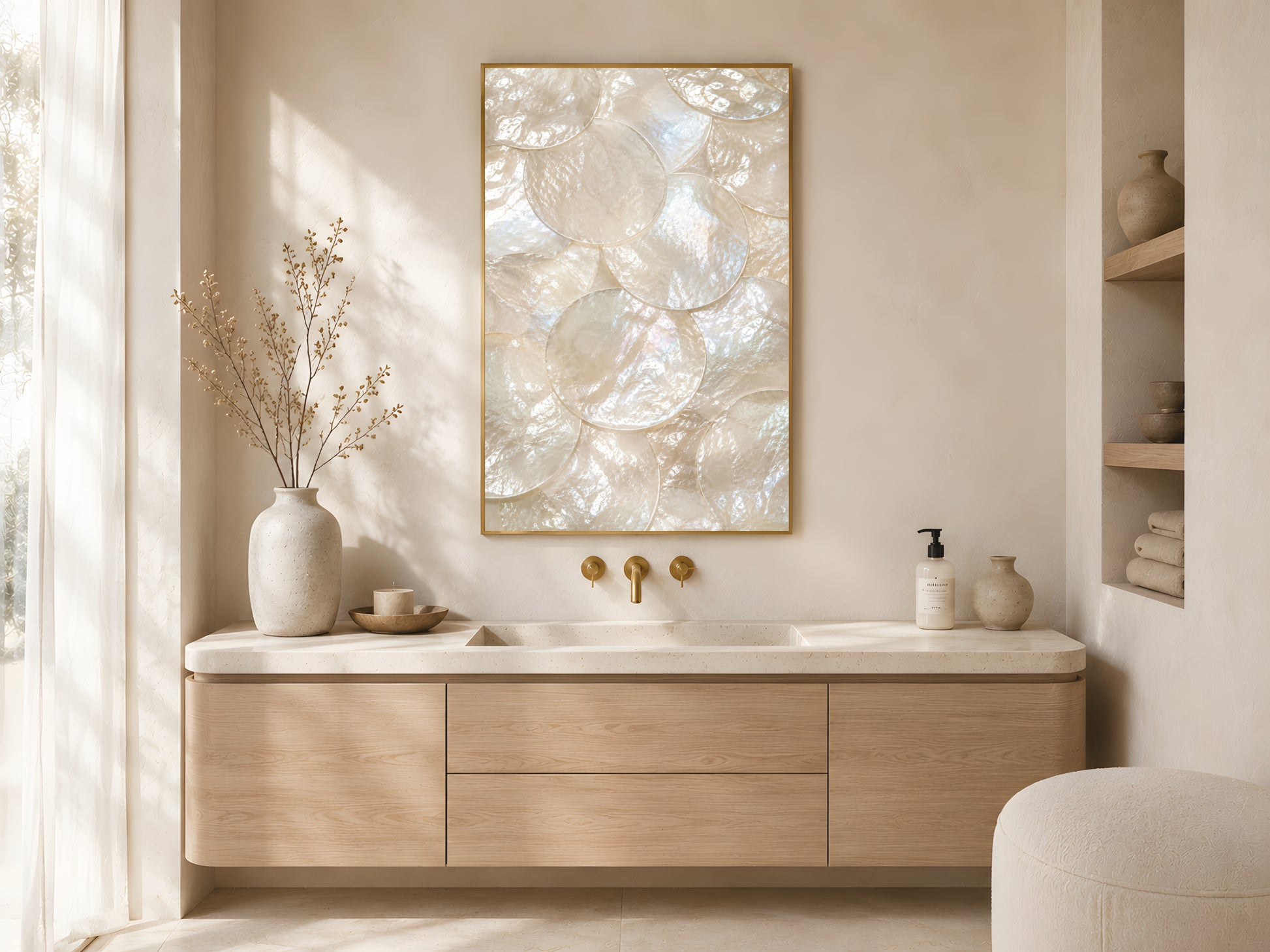 Mother of pearl iridescent shell print in gold frame above wooden bathroom vanity with gold fixtures in warm minimalist Japandi bathroom with cream accessories
