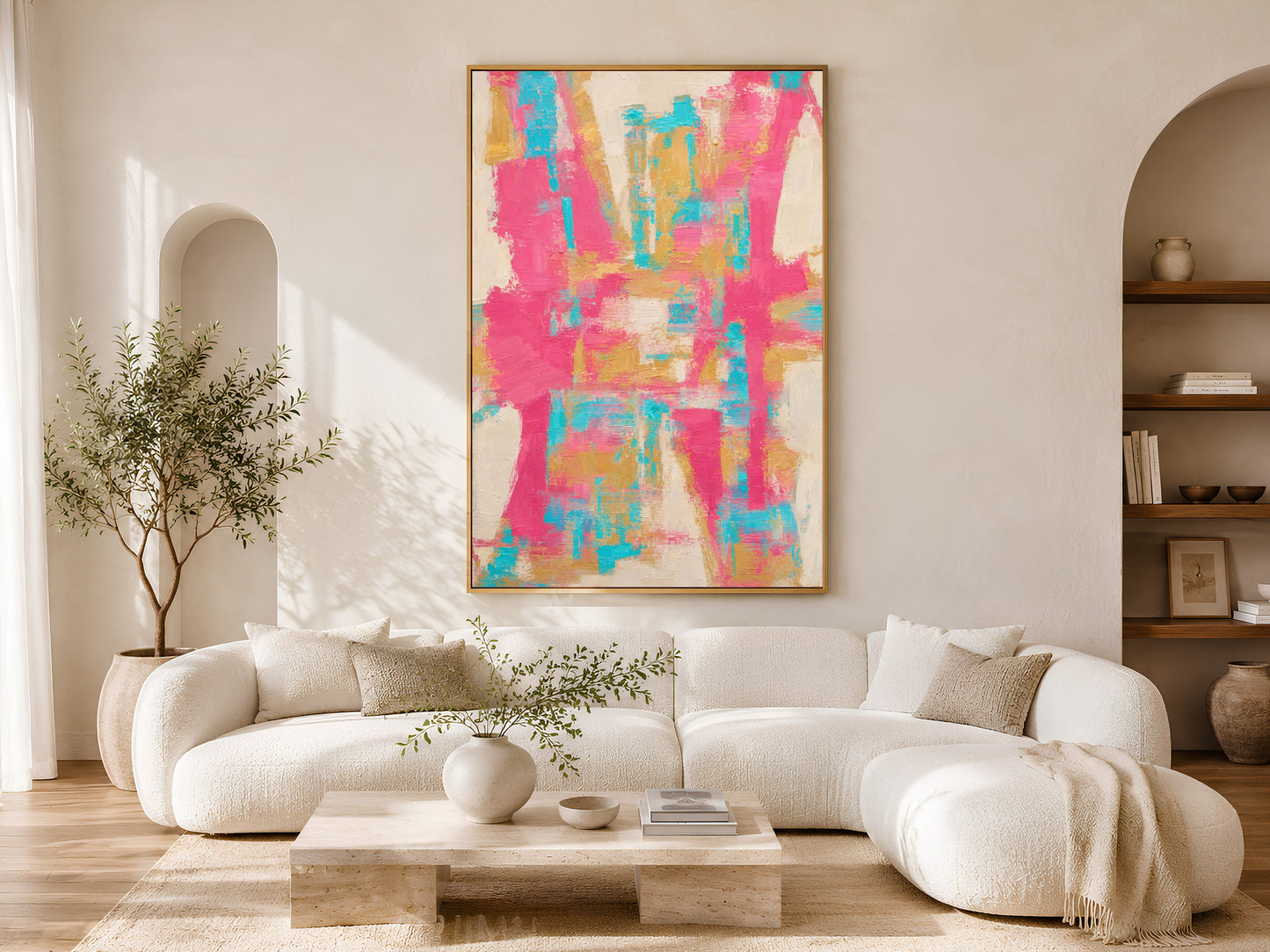 Framed bold fuchsia pink teal and gold abstract impasto print above a white sofa in a bright Scandinavian living room
