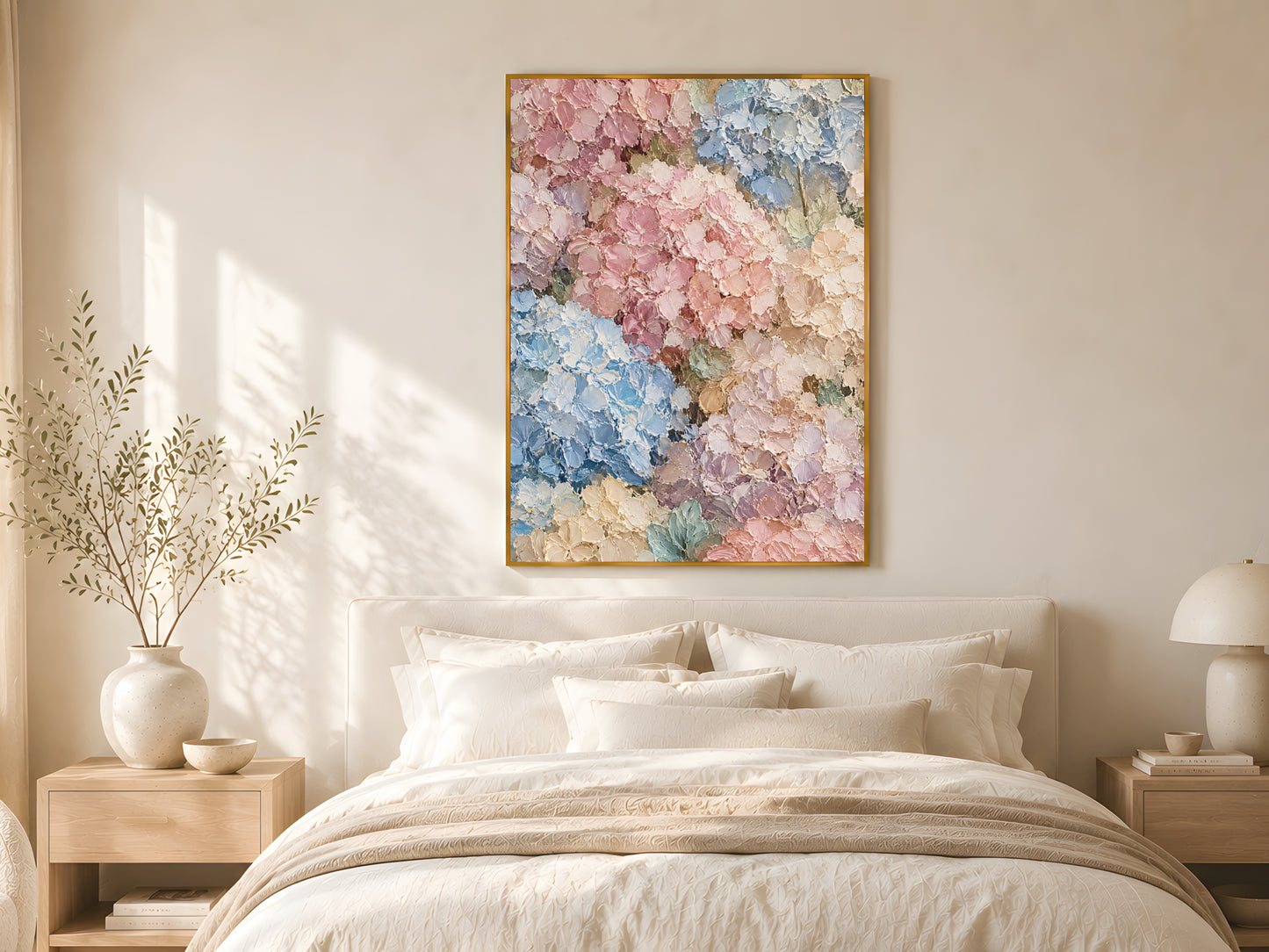 Pastel hydrangea impasto print in a gold frame above a linen bed in a bright minimal bedroom with warm afternoon light
