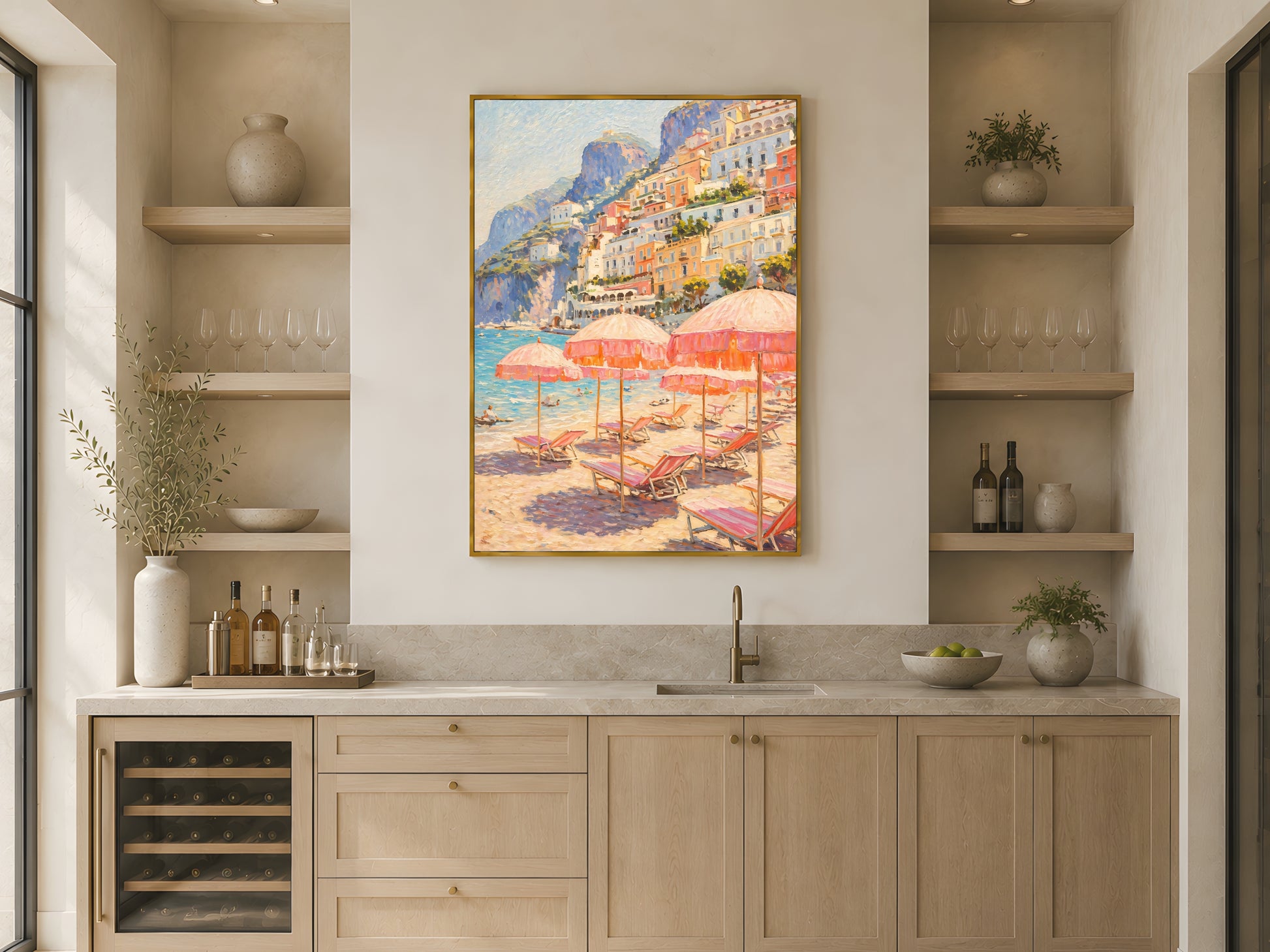 Positano beach club impasto wall art print in gold frame above light wood kitchen counter with wine fridge and open shelving in warm minimalist Japandi kitchen