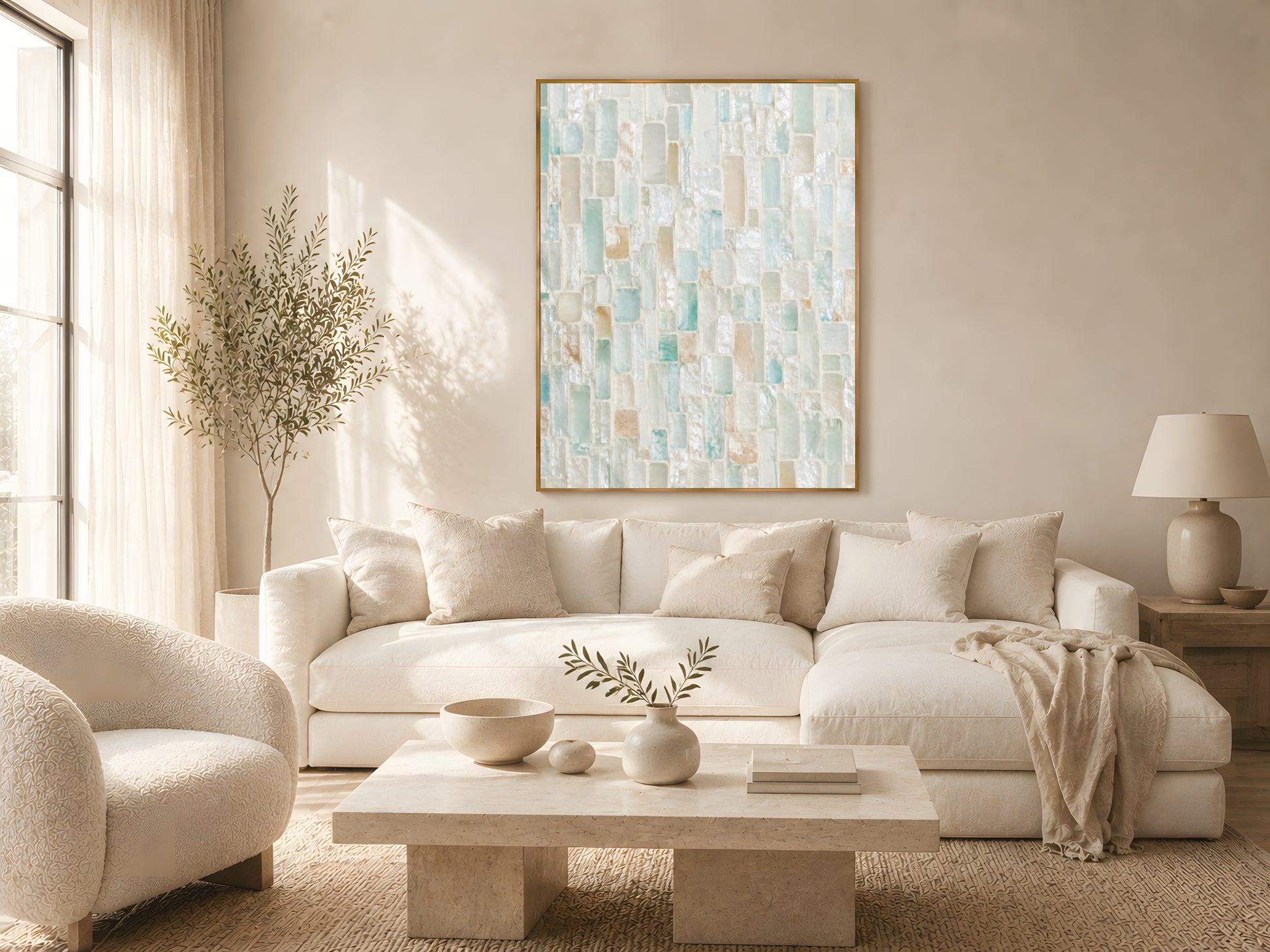 Sea glass mosaic tile wall art in gold frame above cream sofa in warm minimalist Japandi living room with natural wood coffee table and soft natural light
