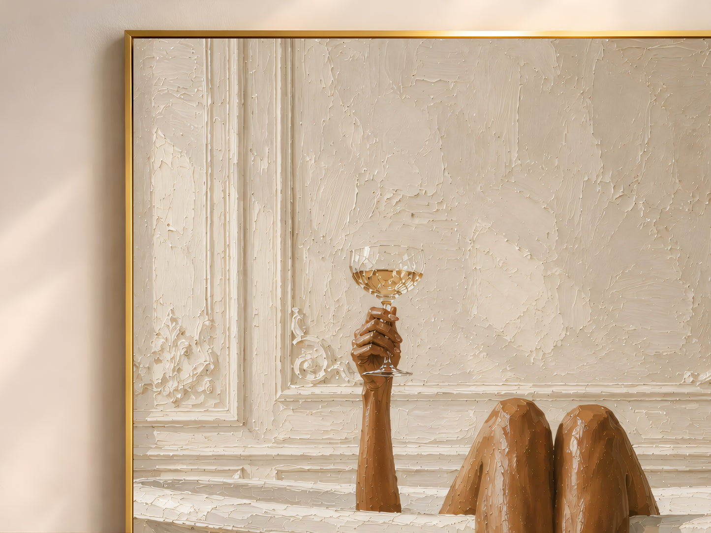 Close-up of the clawfoot tub art print in a gold frame showing bronzed legs over an ornate plaster-molded bathtub and a hand raising a champagne coupe against a warm textured wall