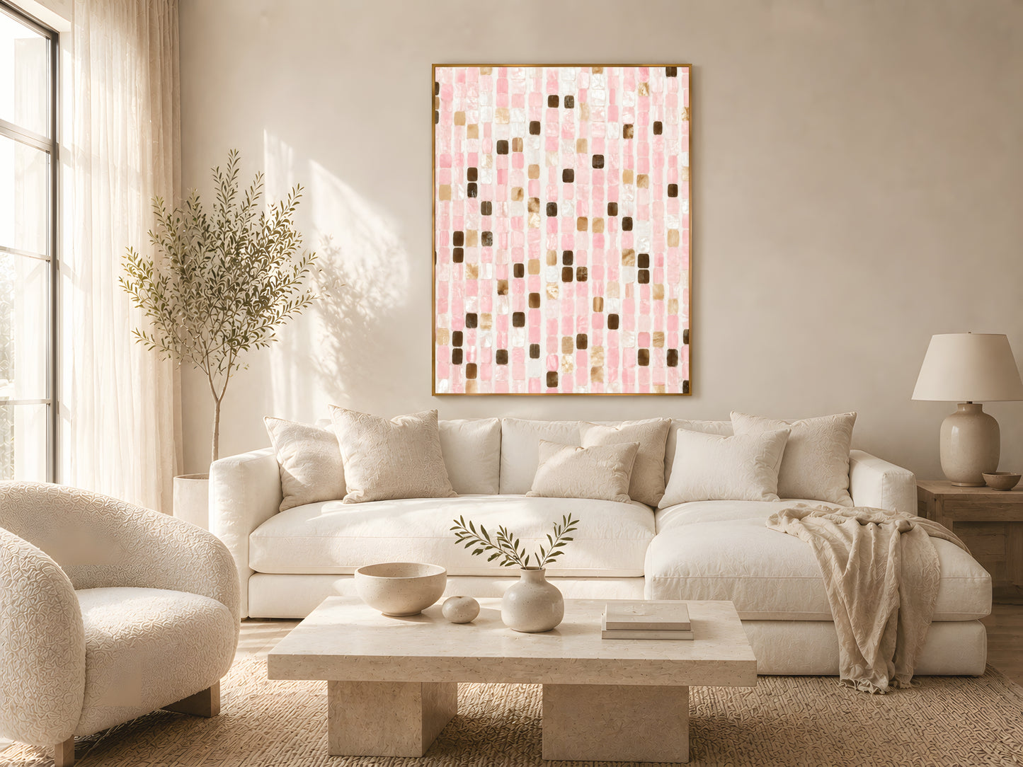 Blush pink mosaic tile abstract print in gold frame above cream sofa in warm minimalist Japandi living room with natural wood coffee table and dried botanicals
