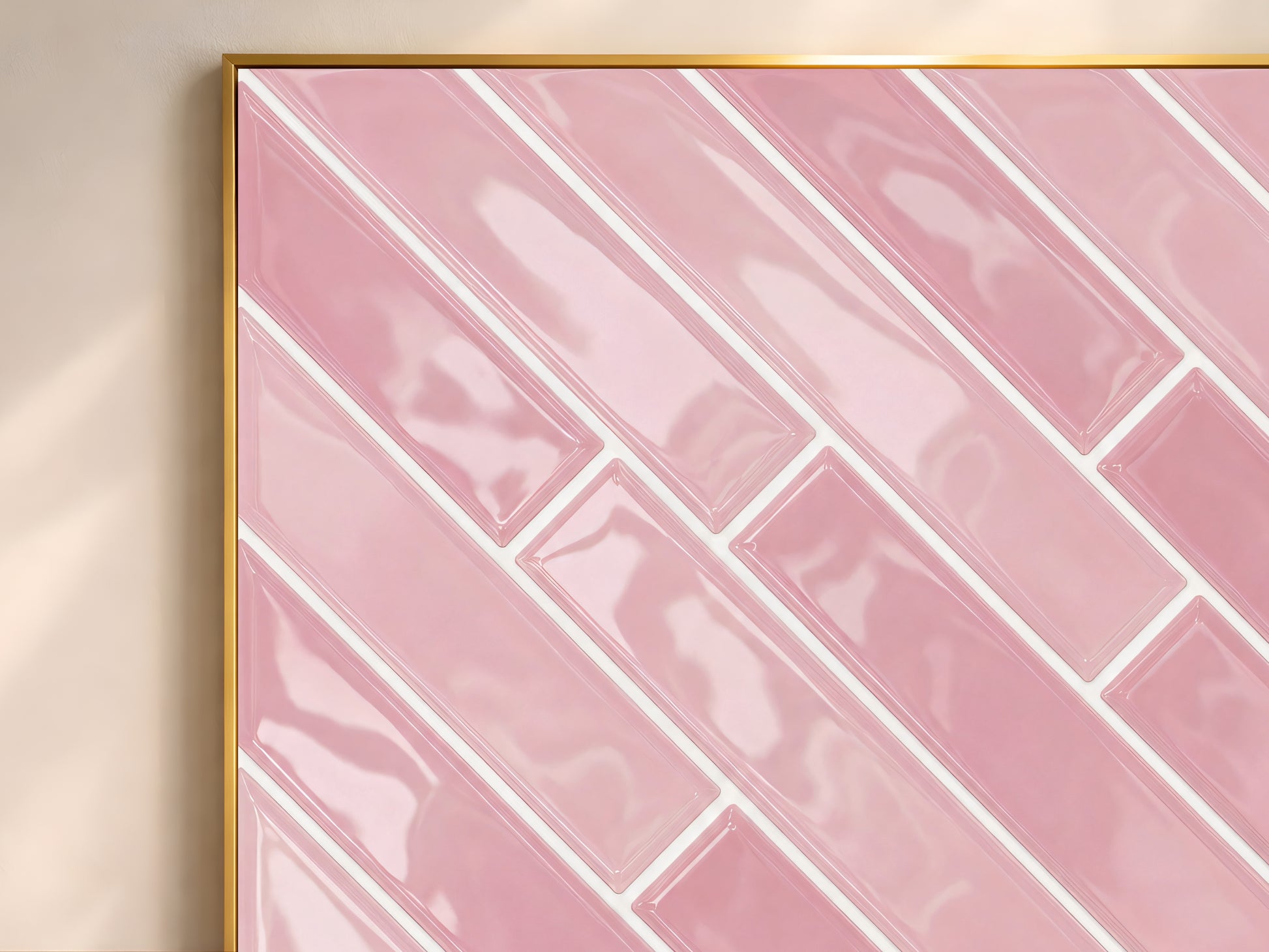 Close-up of the pink herringbone tile wall art print in a gold frame showing glossy blush ceramic tiles in a diagonal herringbone pattern with white grout lines
