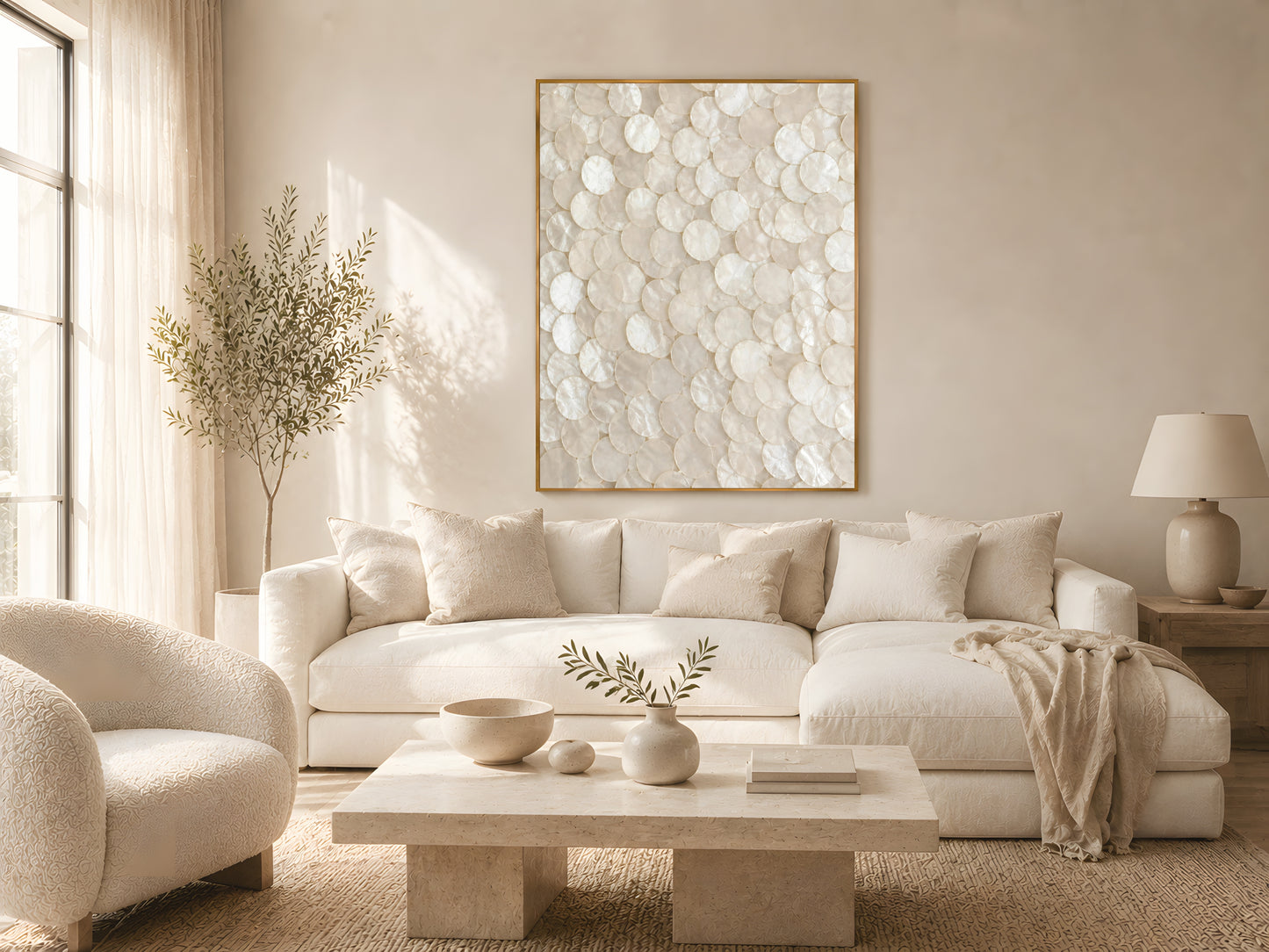 Large pearlescent capiz shell wall art in gold frame above cream sofa in warm minimalist Japandi living room with natural wood coffee table

