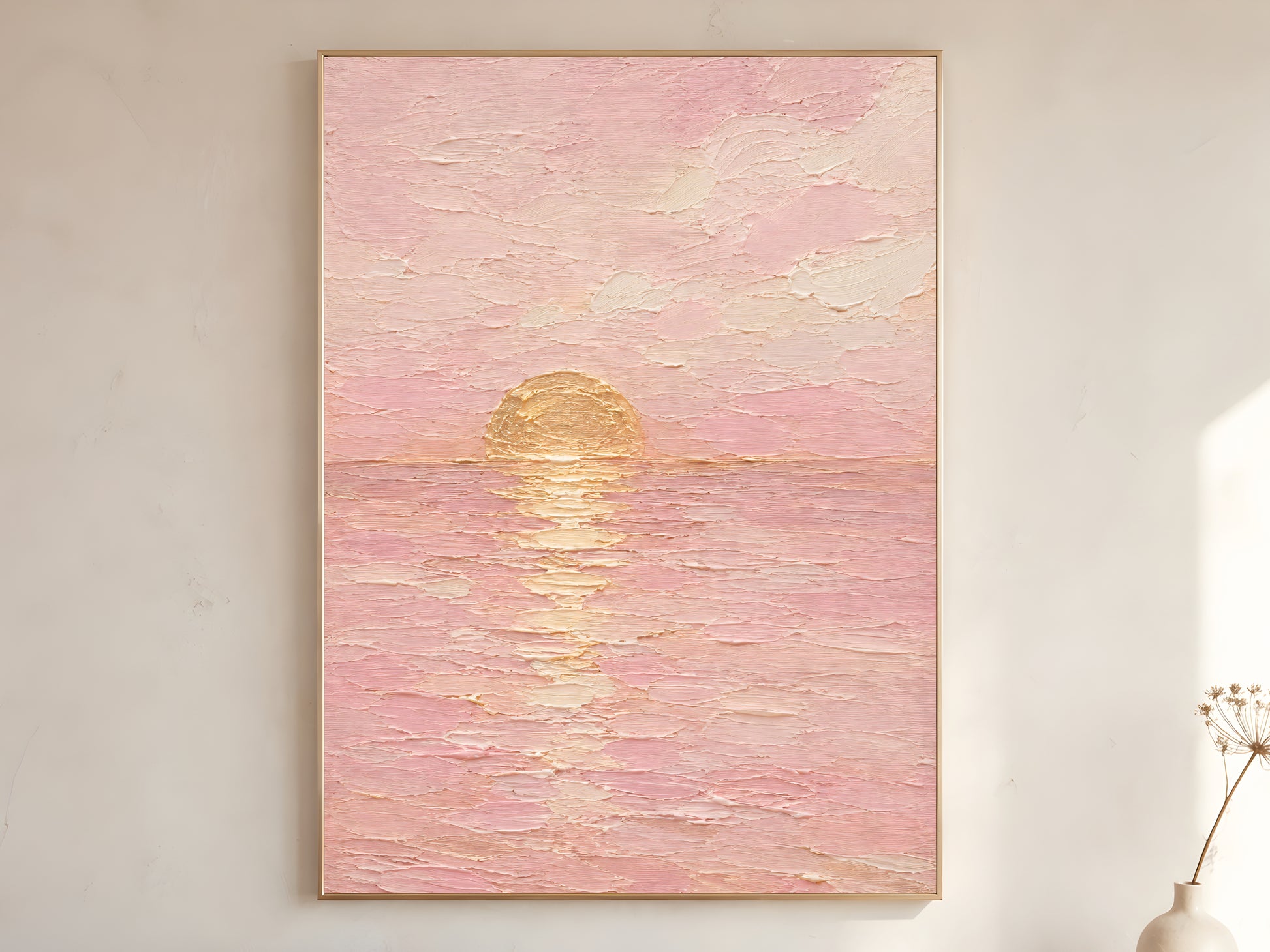 Pink sunset wall art print framed and hanging on a neutral wall with a vase nearby, golden hour ocean reflection.
