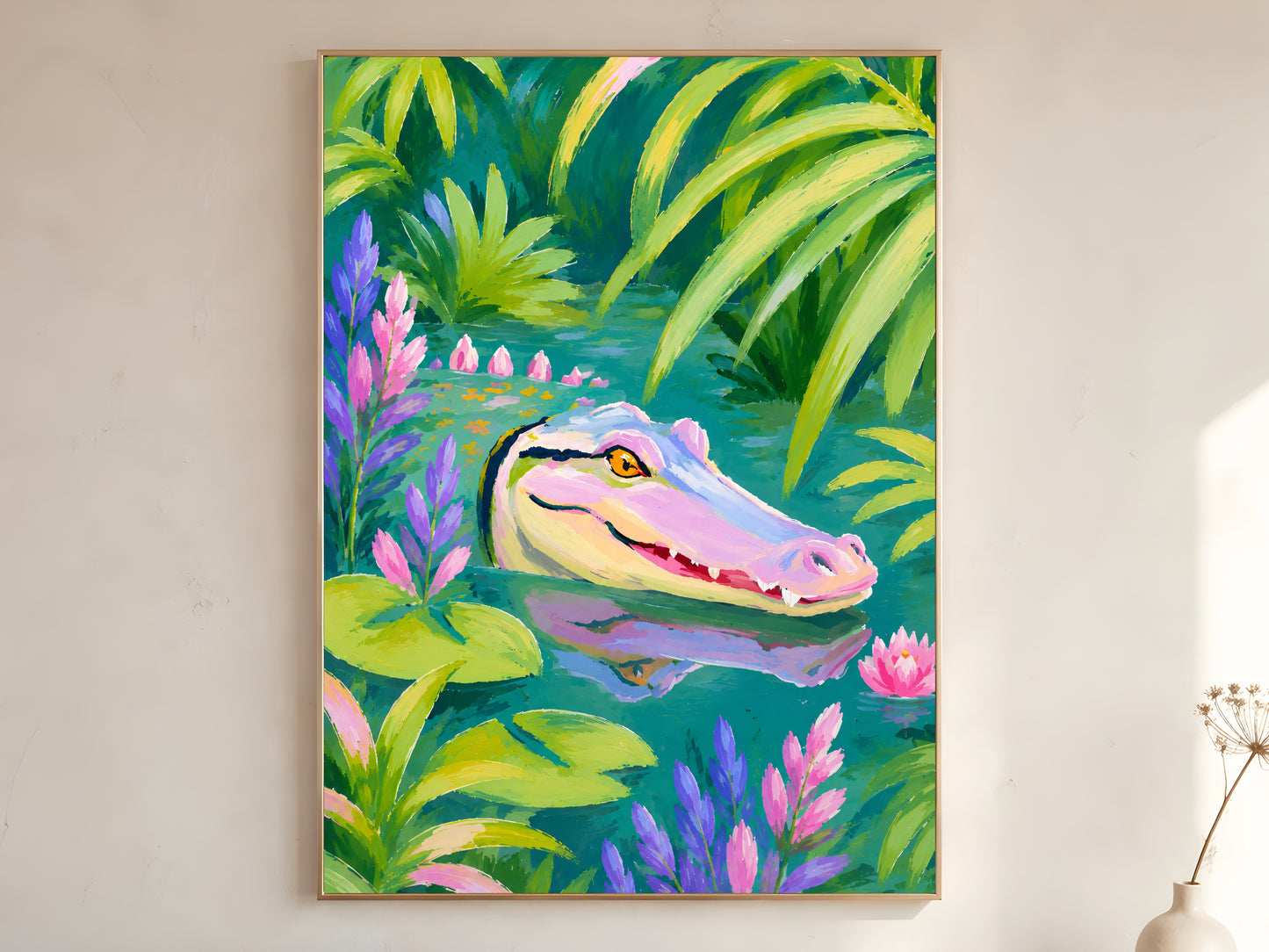 Colorful alligator wall art print in a gold frame leaning against a warm white wall with dried botanicals, showing the full tropical jungle composition with pink and purple florals

