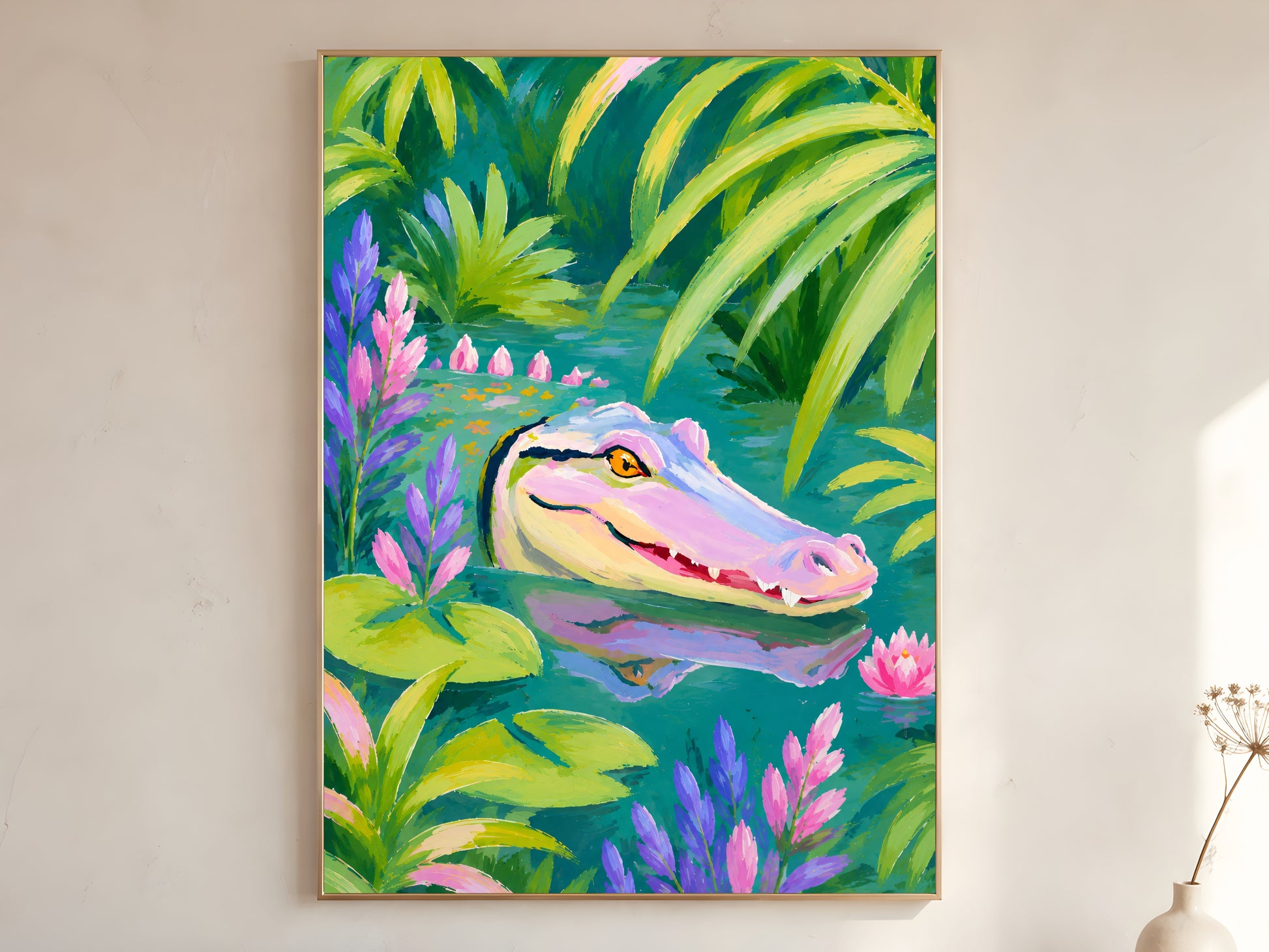 Colorful alligator wall art print in a gold frame leaning against a warm white wall with dried botanicals, showing the full tropical jungle composition with pink and purple florals

