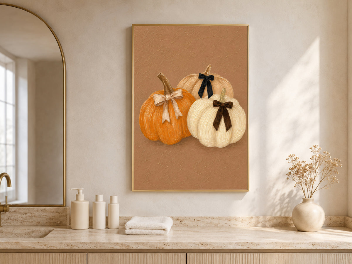 Framed pumpkin trio print with velvet bows in a sunlit arched kitchen