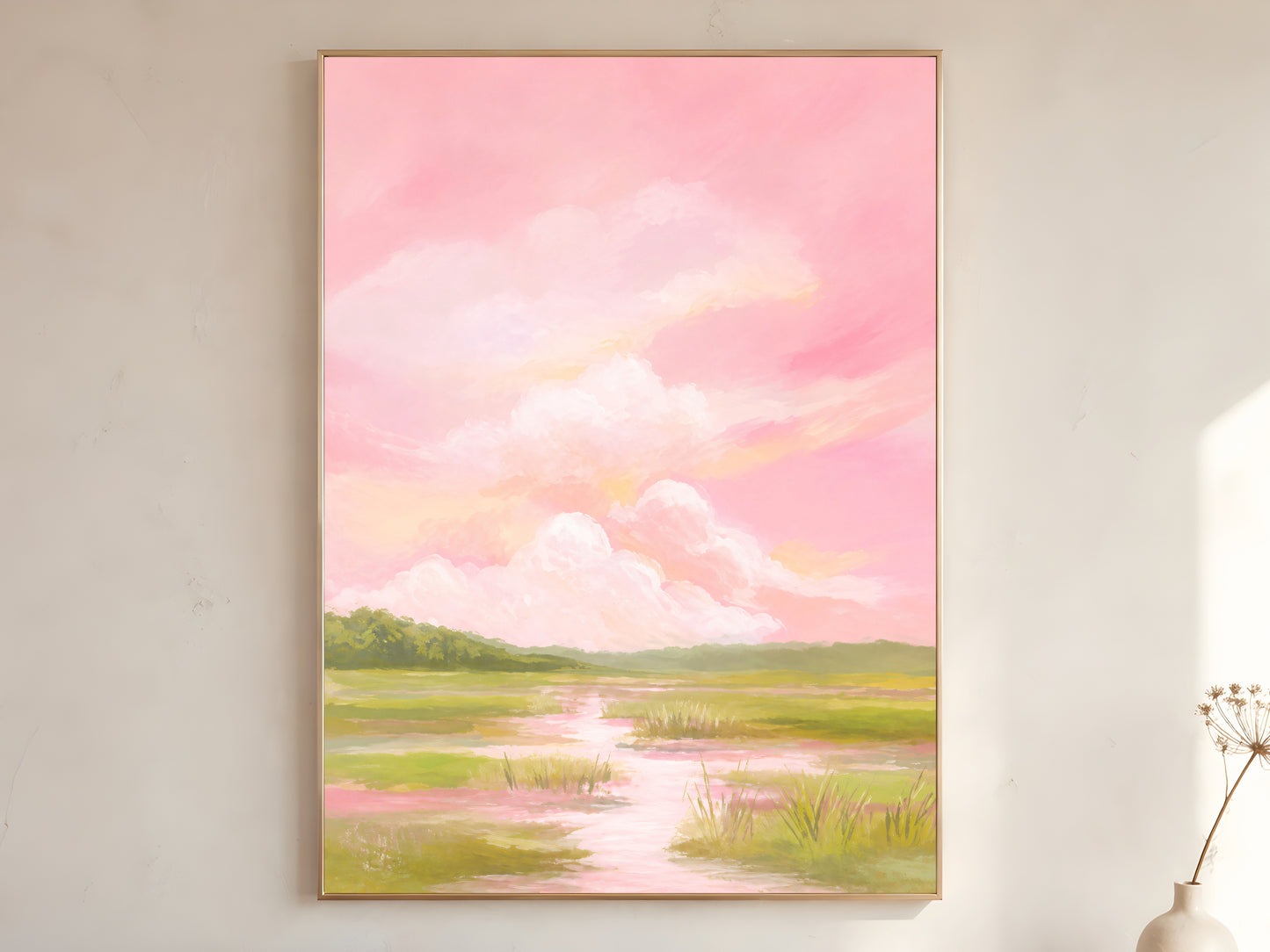 Pink sky marsh landscape wall art framed on neutral wall beside dried flowers
