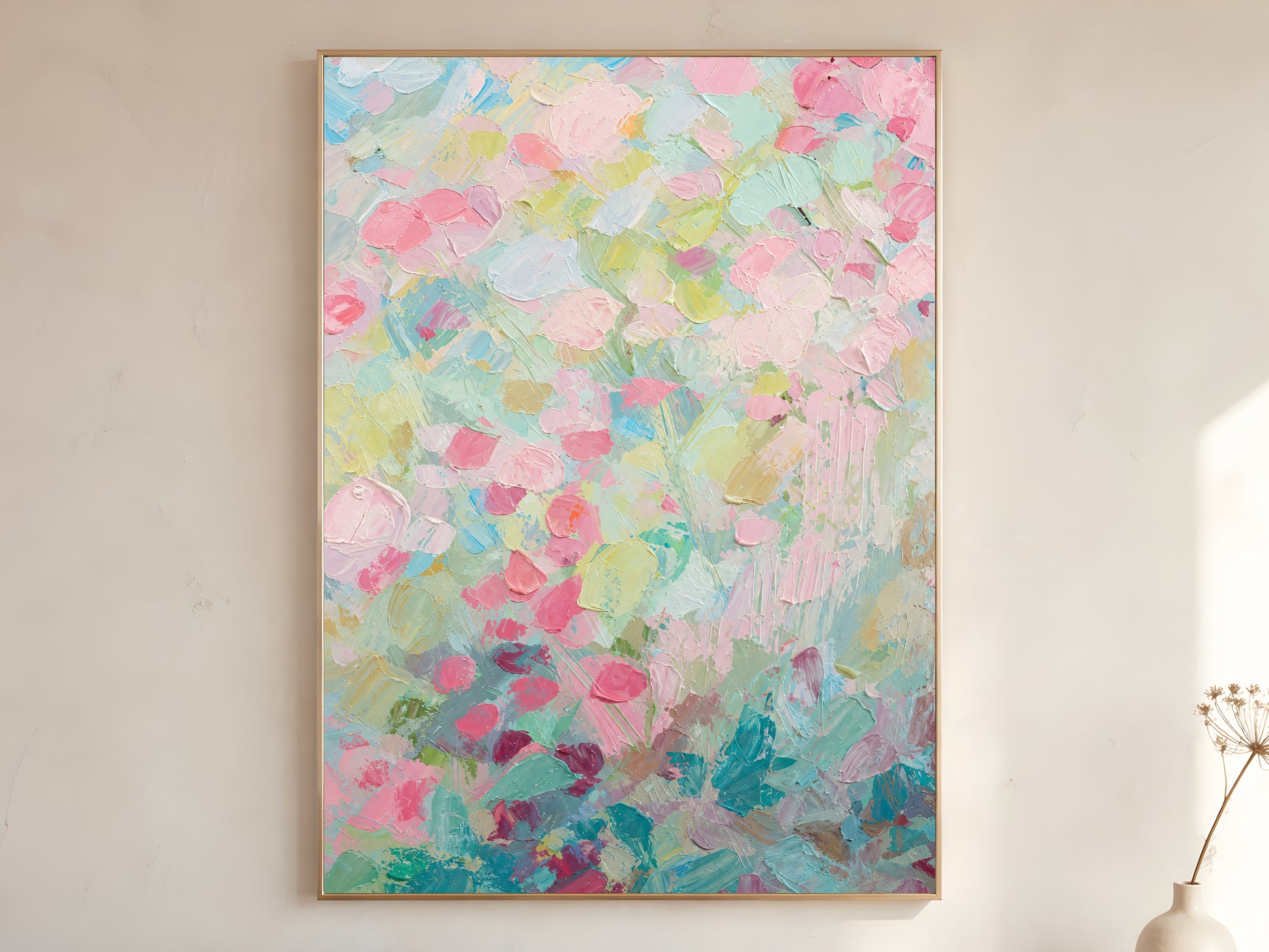 Pastel floral impasto wall art in gold frame on neutral wall beside dried flowers
