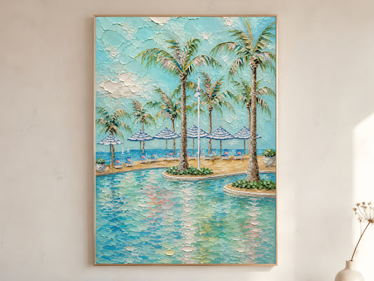 Tropical pool with palm trees and blue striped beach umbrellas impasto oil painting print in a thin natural wood frame, leaning against a warm white wall with a dried wildflower stem

