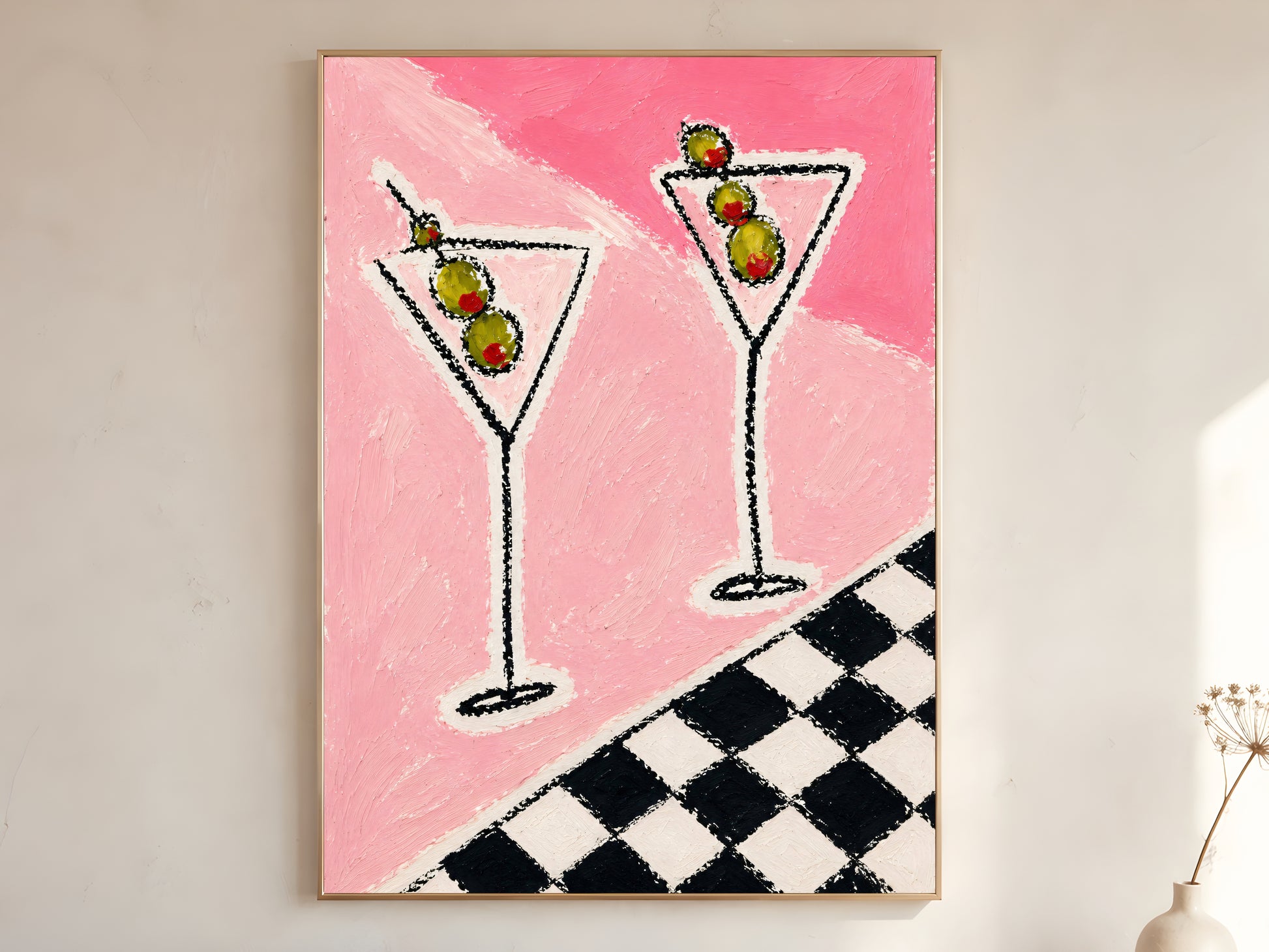 Large framed impasto martini wall art in gold frame leaning against white wall with dried botanicals in bright minimal room
