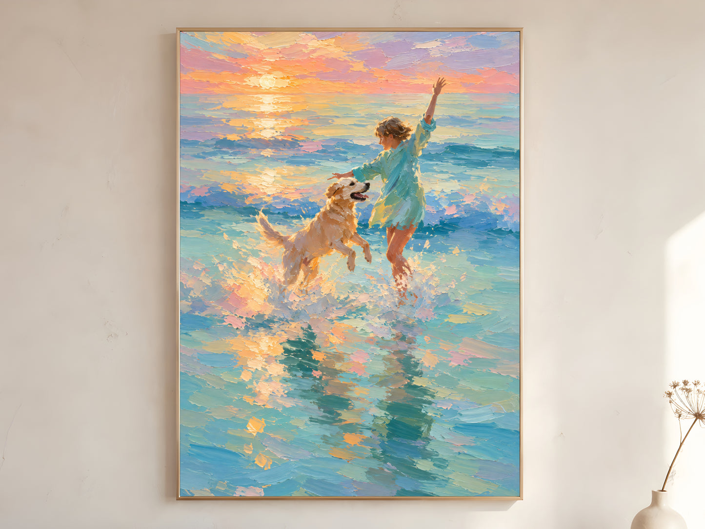 Girl and golden retriever beach sunset impasto oil painting print in a gold frame leaning against a warm white wall with dried botanicals, showing the full painting with teal ocean, peach and lavender sunset sky, and golden light reflecting across the water

