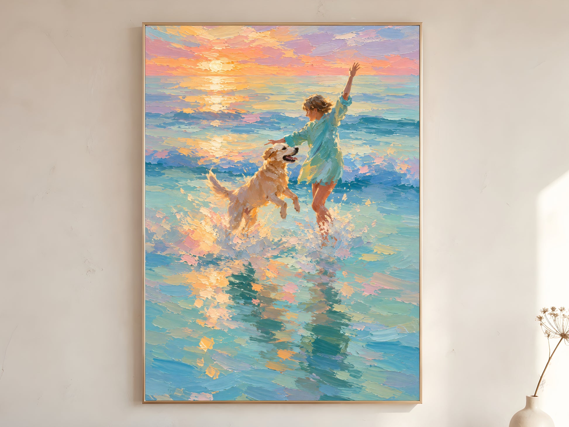 Girl and golden retriever beach sunset impasto oil painting print in a gold frame leaning against a warm white wall with dried botanicals, showing the full painting with teal ocean, peach and lavender sunset sky, and golden light reflecting across the water

