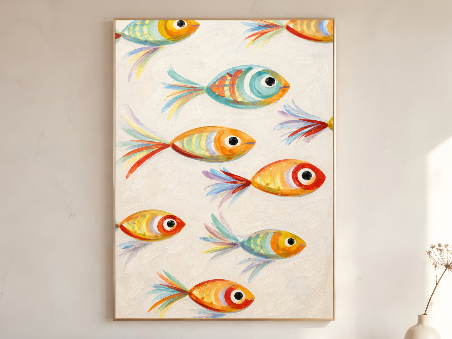 Large framed impasto whimsical fish wall art in gold frame leaning against white wall with dried botanicals in bright minimal room
