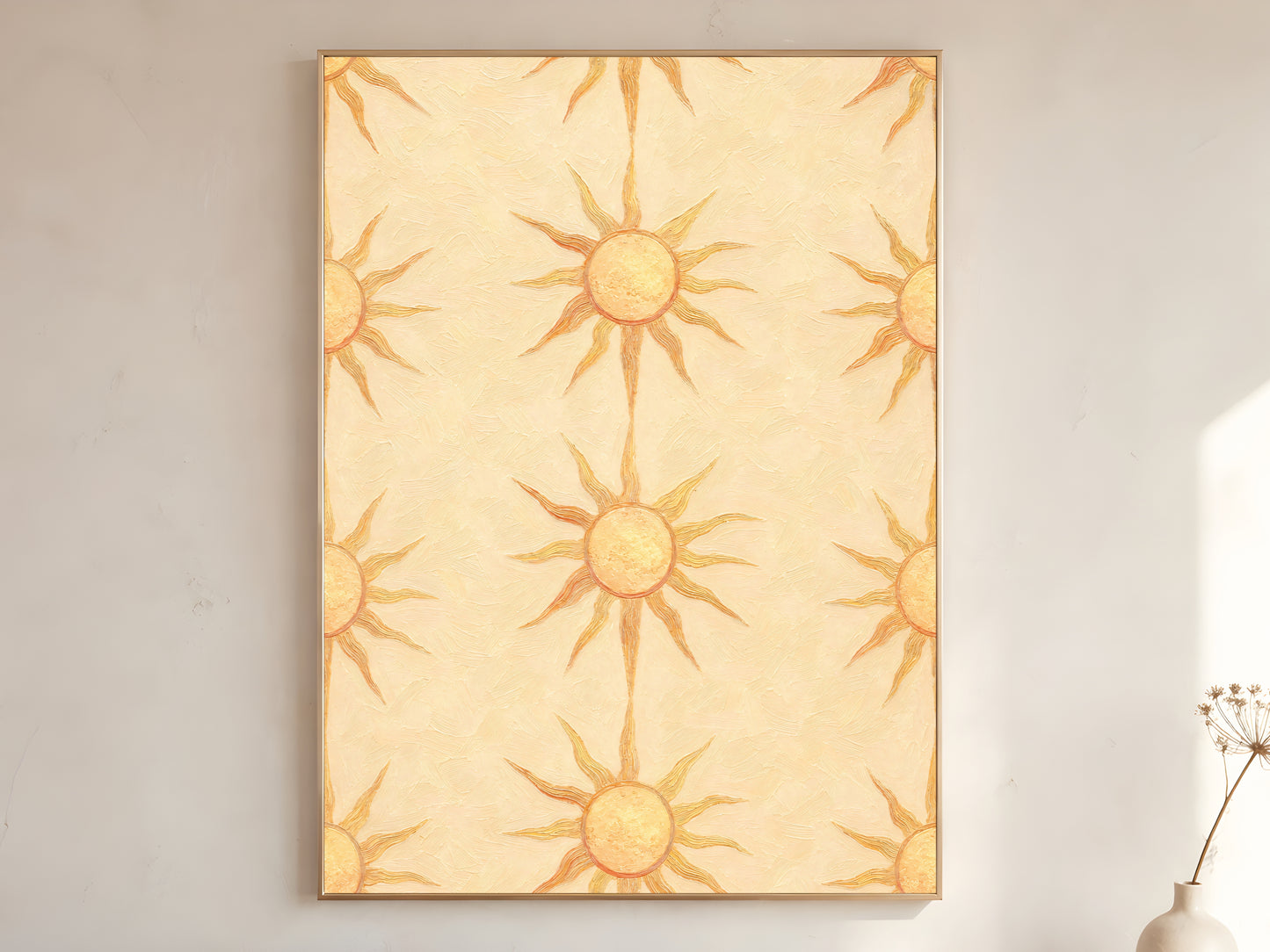 Boho sun wall art print in wooden frame on a cream wall, repeating butter yellow sunburst pattern, with a stoneware vase and dried branches.
