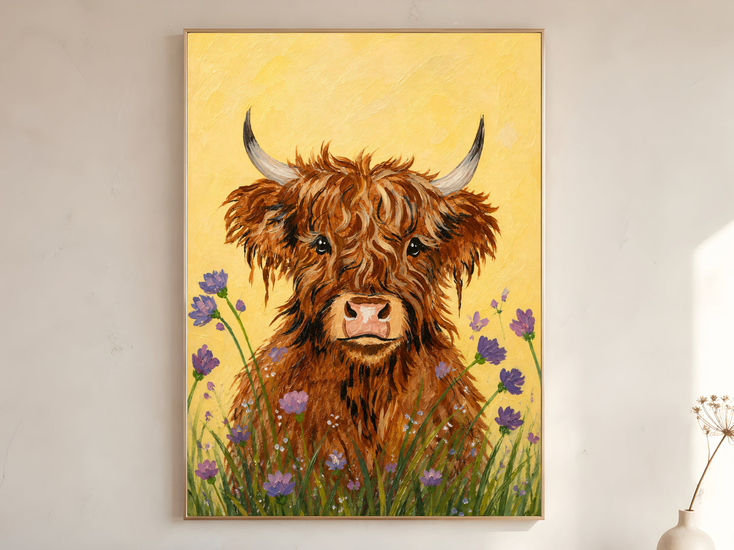 Large framed impasto baby highland cow wall art in gold frame leaning against white wall with dried botanicals in bright minimal room
