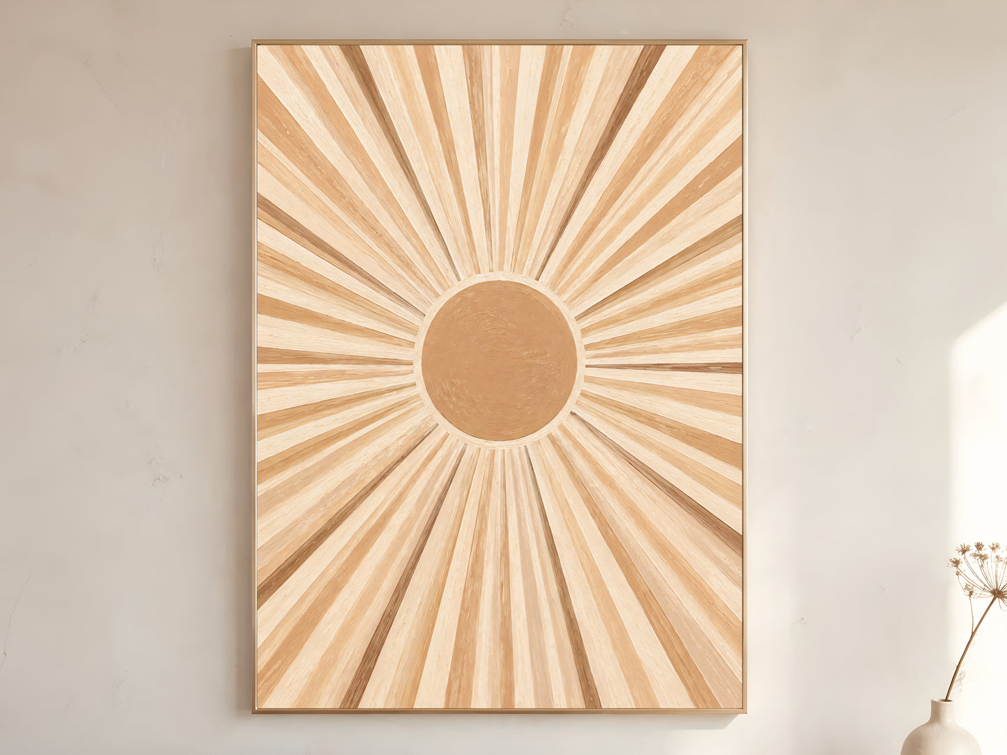 Large framed impasto sunburst wall art in gold frame leaning against white wall with dried botanicals in bright minimal room
