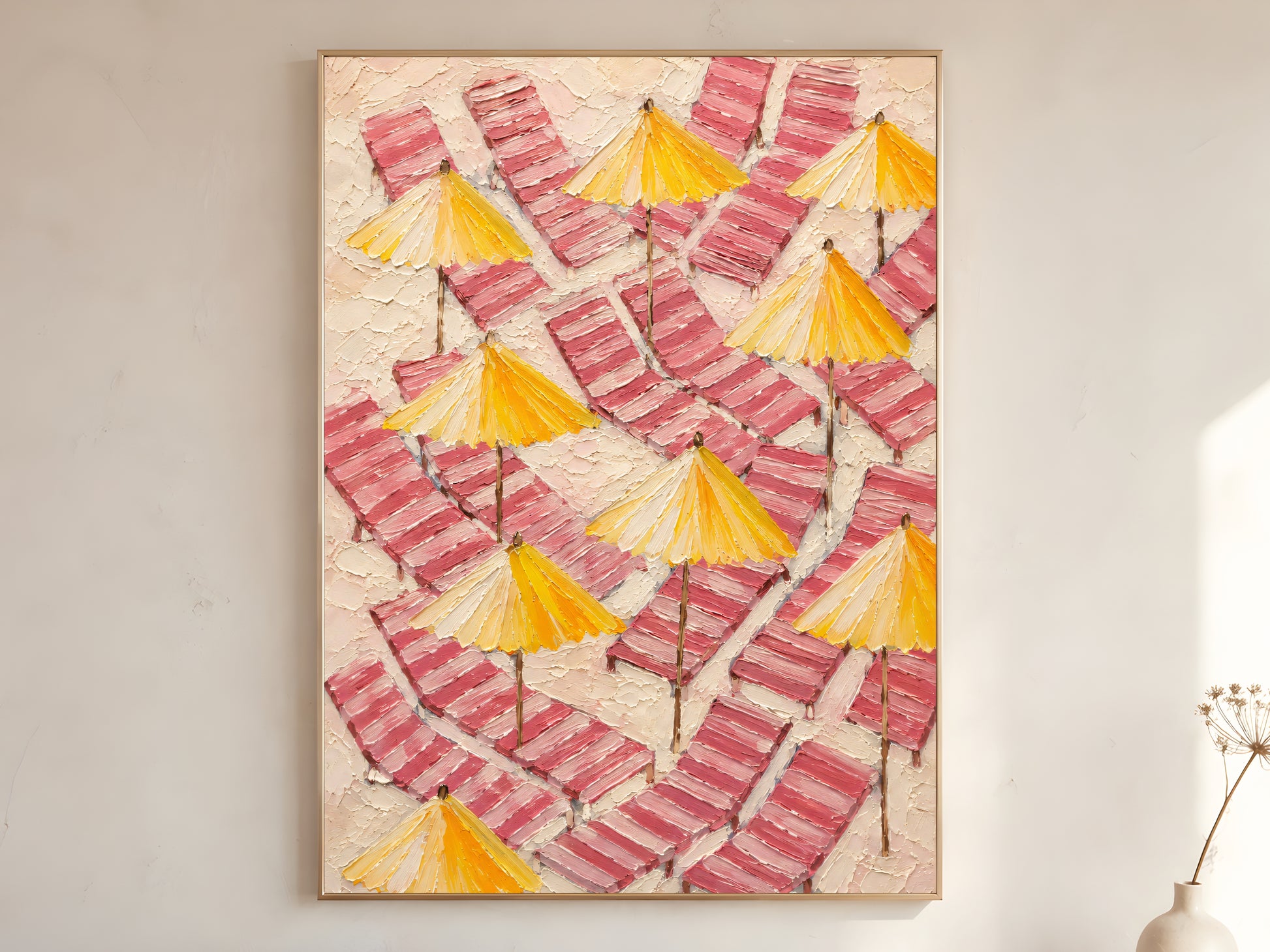 Pink and yellow beach umbrella wall art printable featuring striped loungers and sunny parasols displayed in a warm neutral interior.
