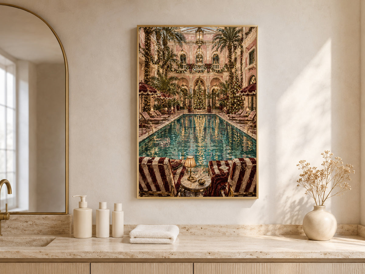 Palm court Christmas painting framed above a bathroom vanity beneath an arched window