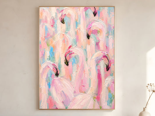 Large framed impasto flamingo flock wall art in gold frame leaning against white wall with dried botanicals in bright minimal room
