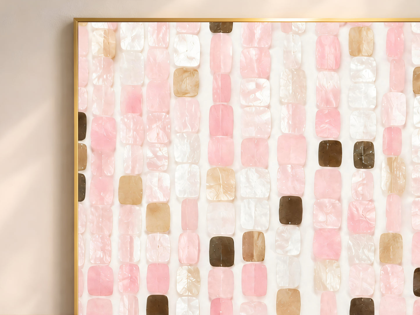 Close-up of pink mosaic tile wall art in gold frame showing blush pink pearl white warm champagne and deep espresso brown iridescent tile pieces catching warm natural light
