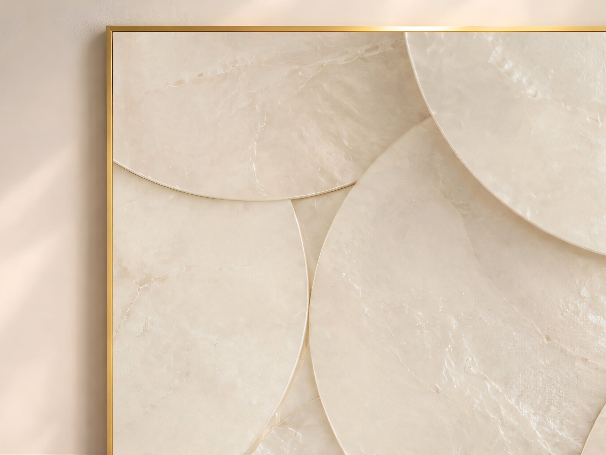 Close-up of minimalist capiz shell disc wall art in gold frame showing large overlapping chalk white and warm ivory shell circles on warm neutral wall
