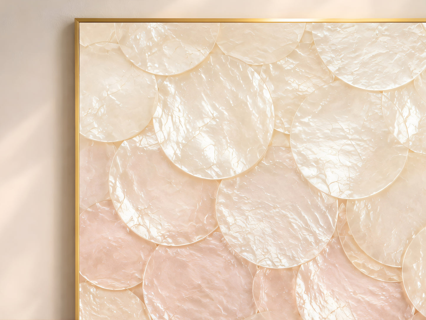Close-up of pastel ombré capiz shell wall art showing overlapping pearlescent shell discs in blush pink pale cream and soft aqua teal gradient

