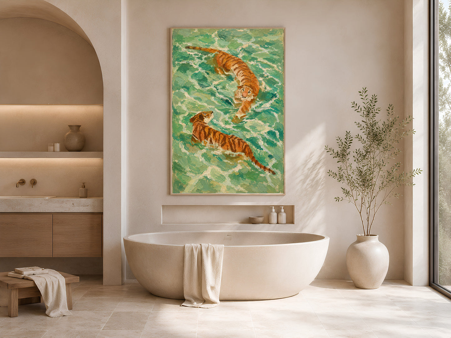 Framed swimming tiger print in a soft neutral bathroom with a freestanding bathtub, white ceramic vessels, and dried botanicals beside an arched window
