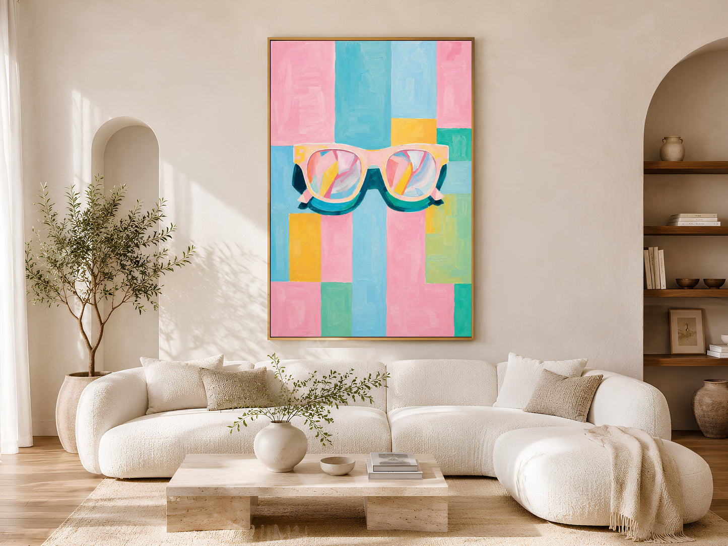Framed impasto retro sunglasses print on warm white wall in minimal living room with curved cream sofa and arch window

