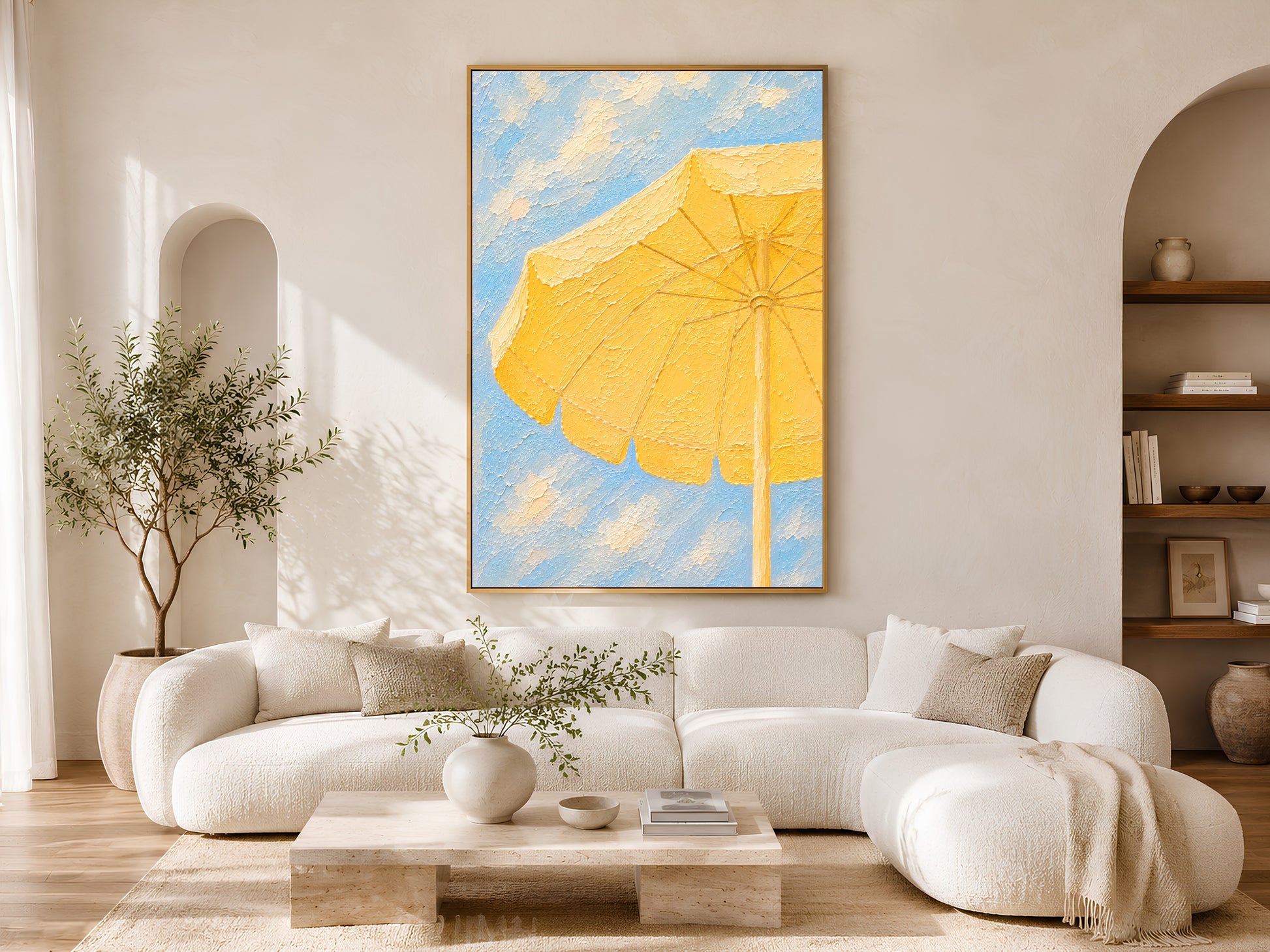 Framed yellow beach umbrella impasto art print in a warm neutral living room with white curved sofa, round coffee table and olive tree
