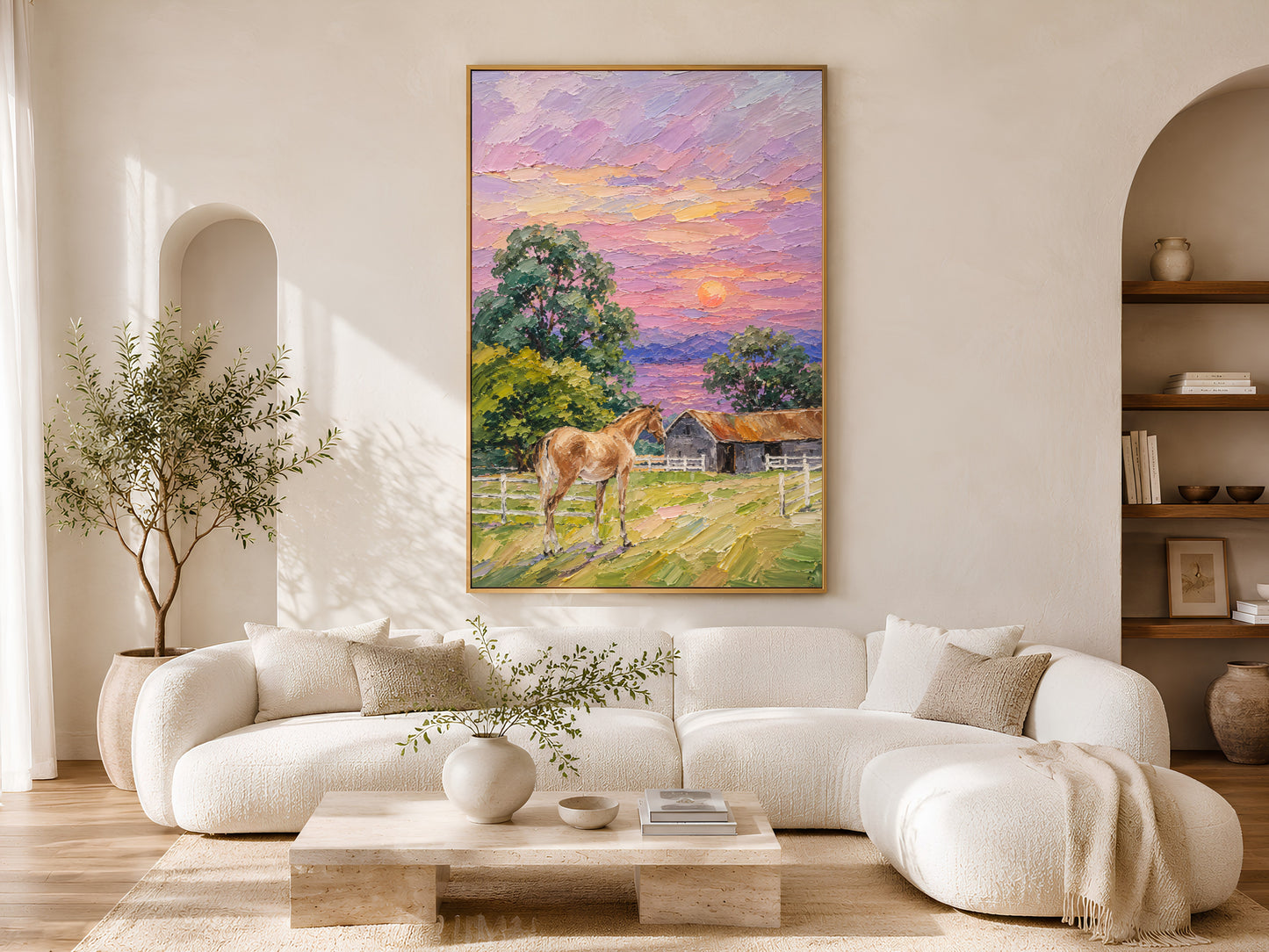 Farmhouse horse sunset impasto painting in a gold frame above a curved white sofa in a bright Scandinavian living room with arched shelving, olive tree, and warm natural light
