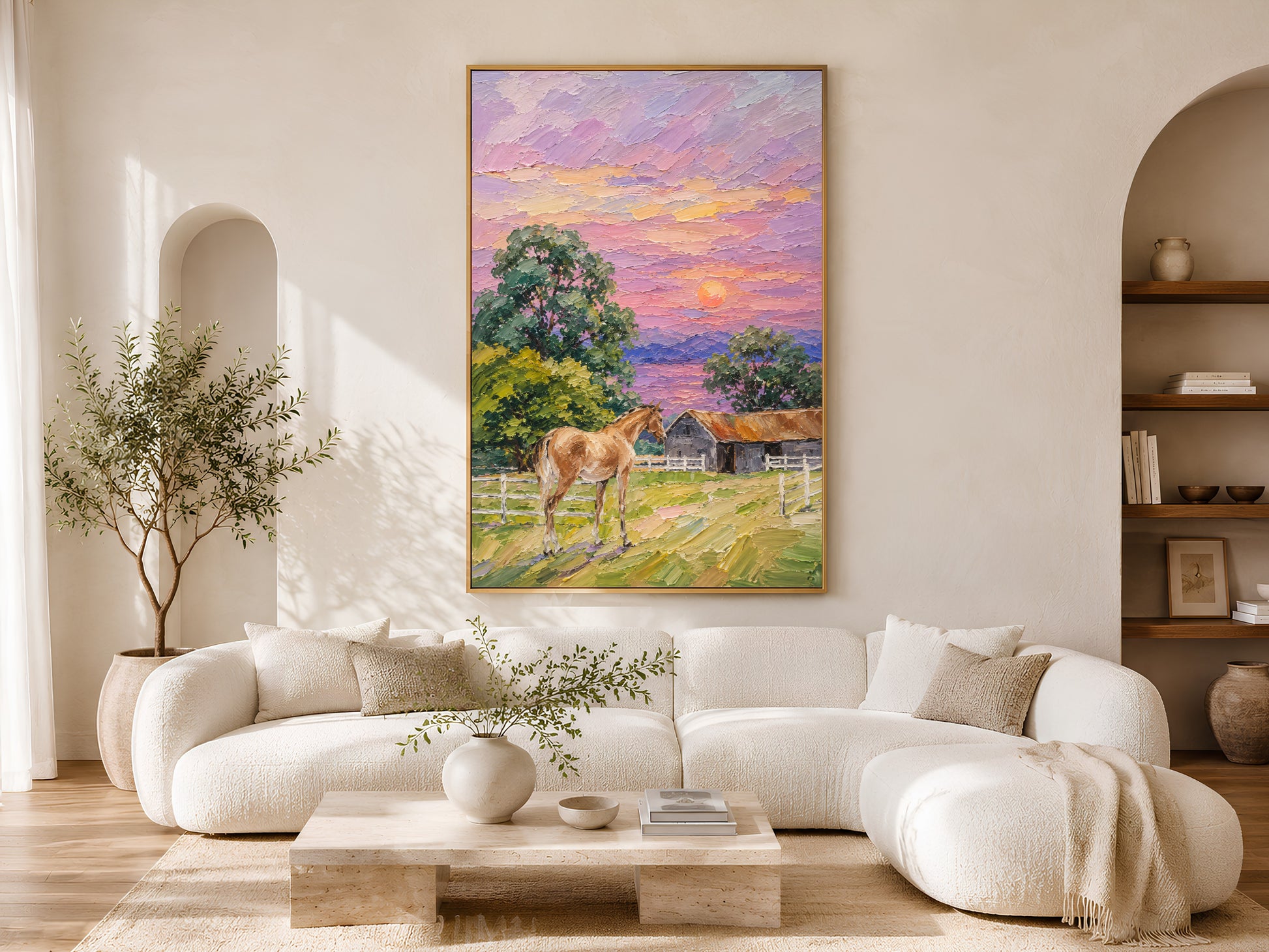 Farmhouse horse sunset impasto painting in a gold frame above a curved white sofa in a bright Scandinavian living room with arched shelving, olive tree, and warm natural light

