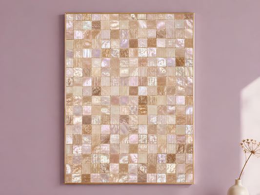 Mother of pearl mosaic wall art print in a gold frame hanging on a dusty mauve wall beside a vase of dried flowers.