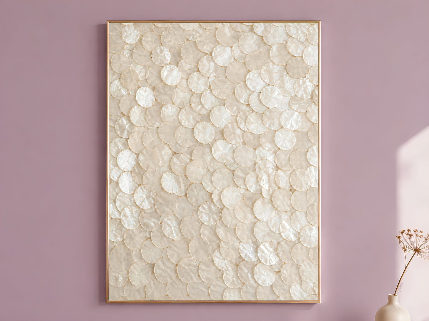 Capiz shell wall art in a gold frame hanging on a dusty mauve wall, champagne mother of pearl texture print
