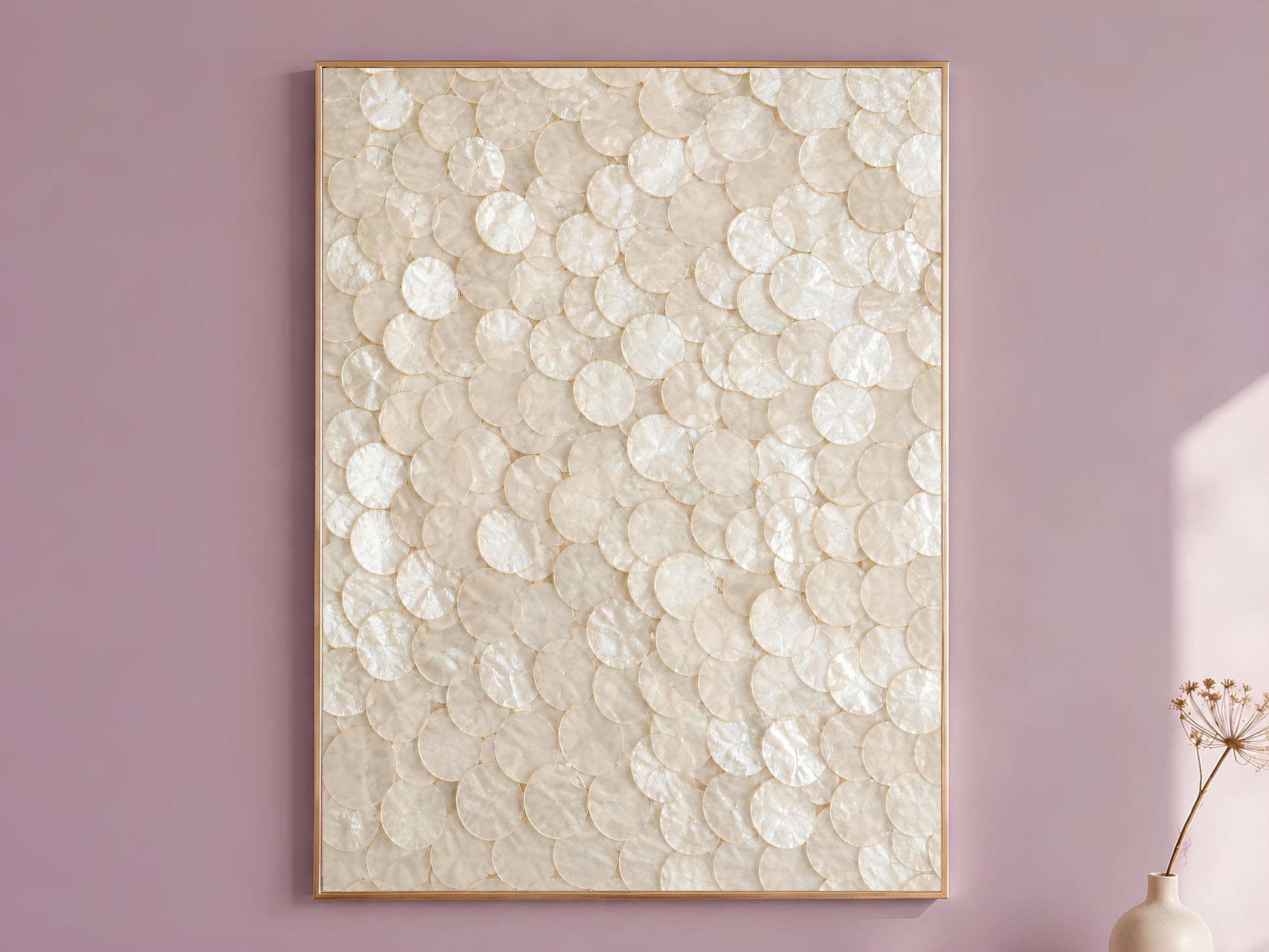 Capiz shell wall art in a gold frame hanging on a dusty mauve wall, champagne mother of pearl texture print
