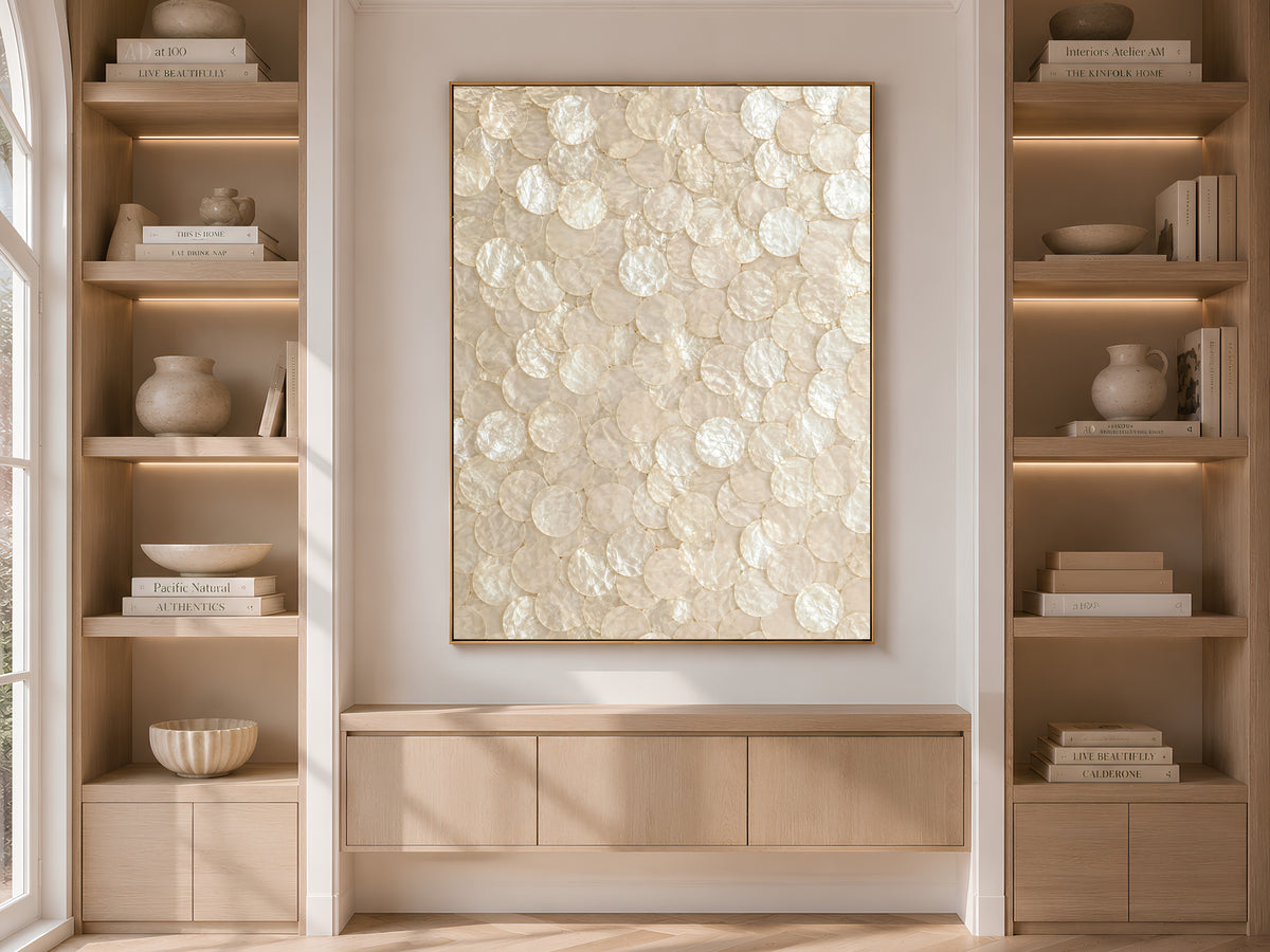 Capiz shell wall art print displayed between styled bookshelves