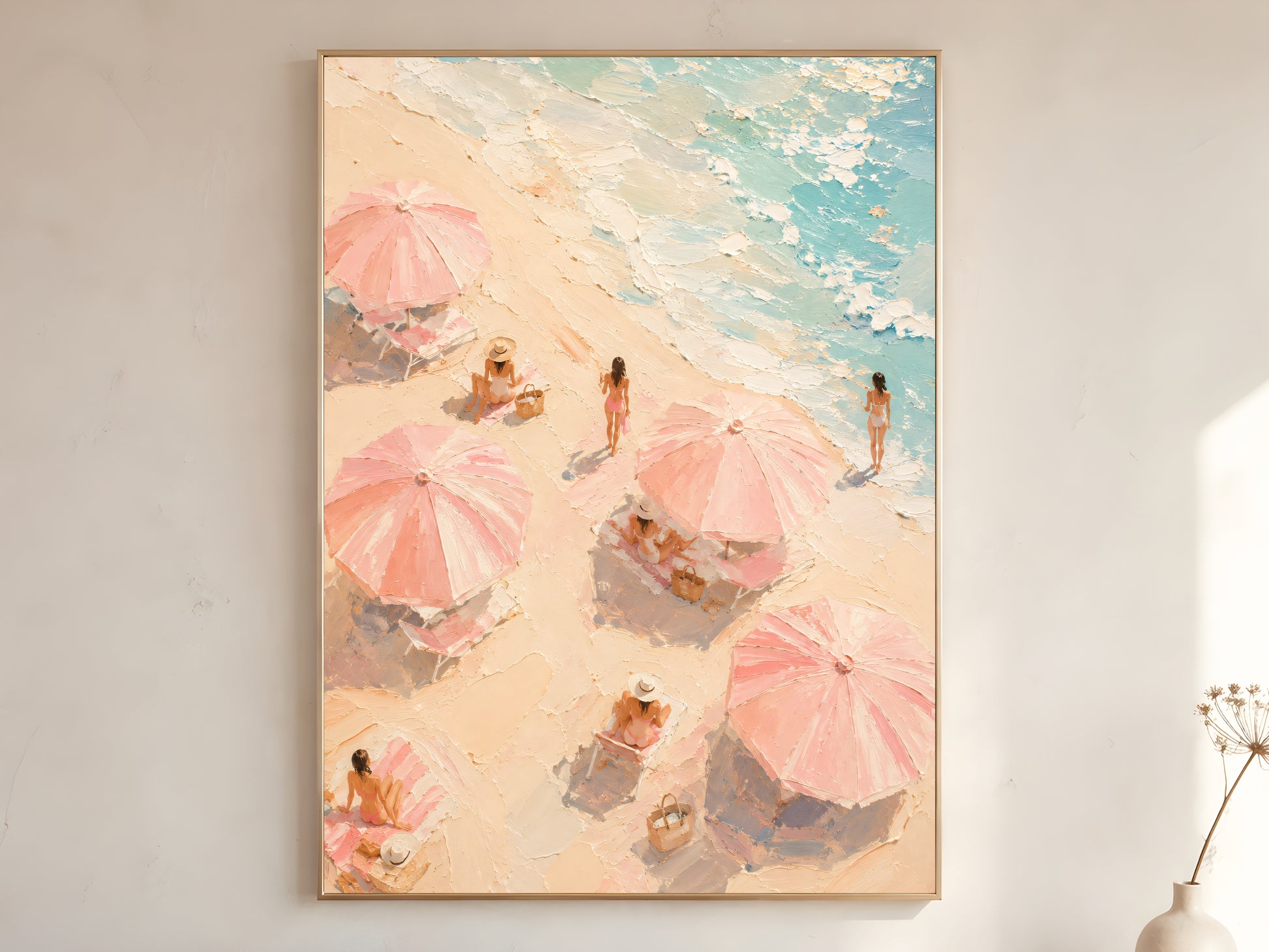 Pink beach umbrella oil painting in gold frame leaning against a white wall with dried florals