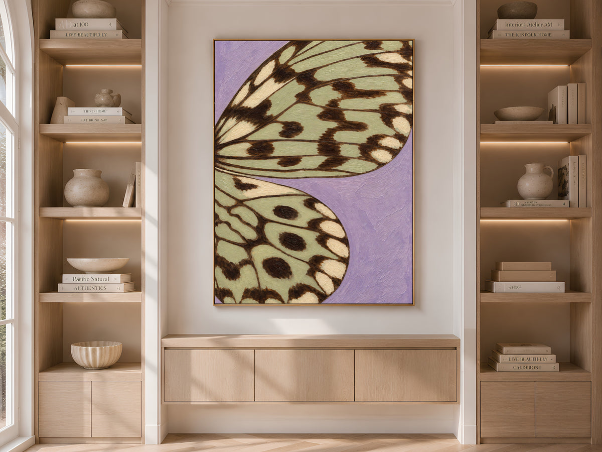 Lavender sage green butterfly wing print framed on built-in shelving in a neutral living room