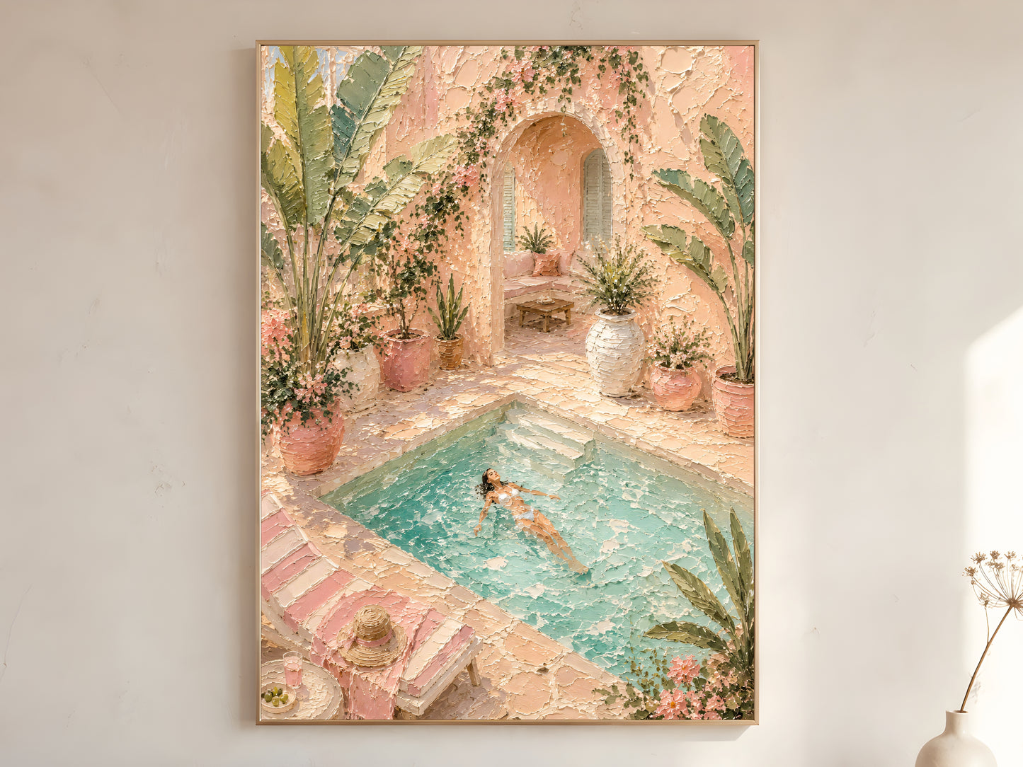 Mediterranean pool villa impasto wall art print in blush pink, teal and tropical green in a gold frame on a warm white wall with dried stems
