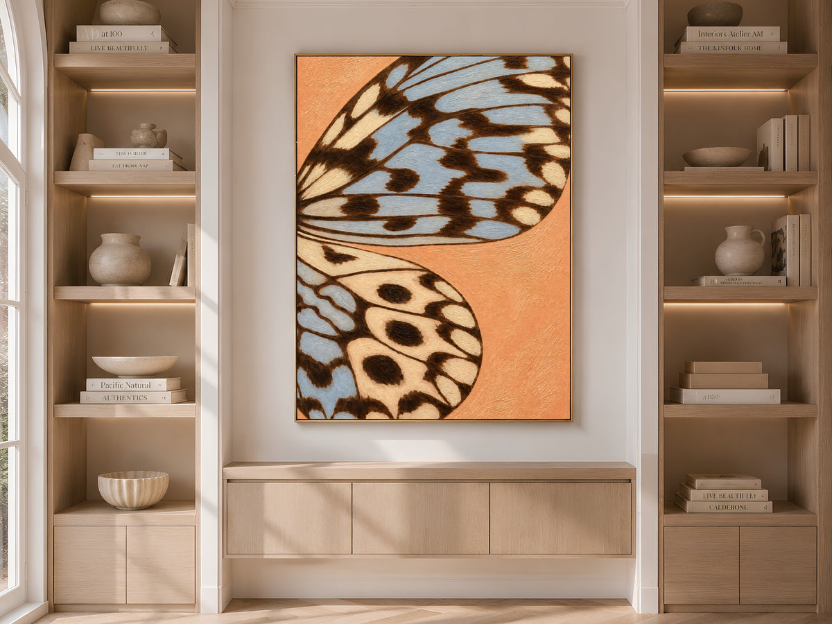 Terracotta and blue butterfly wing print framed on built-in shelving in a warm neutral living room