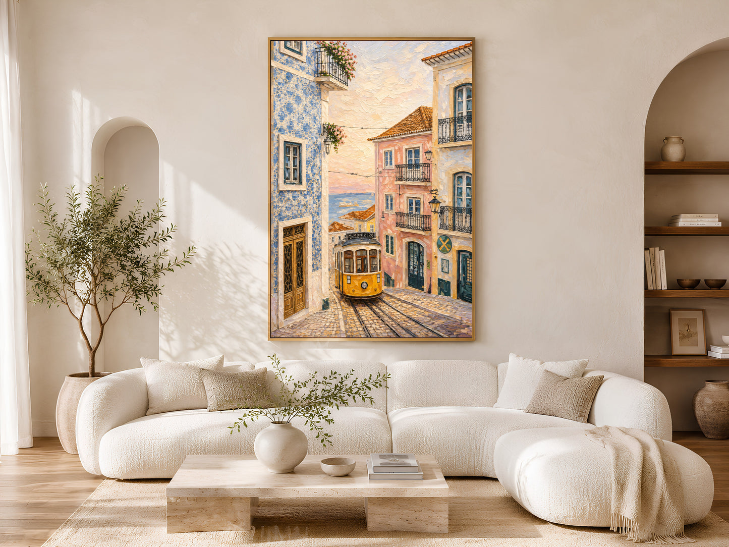 Mediterranean Lisbon tram wall art printable hanging above a cream curved sofa in a warm coastal-inspired luxury living room.