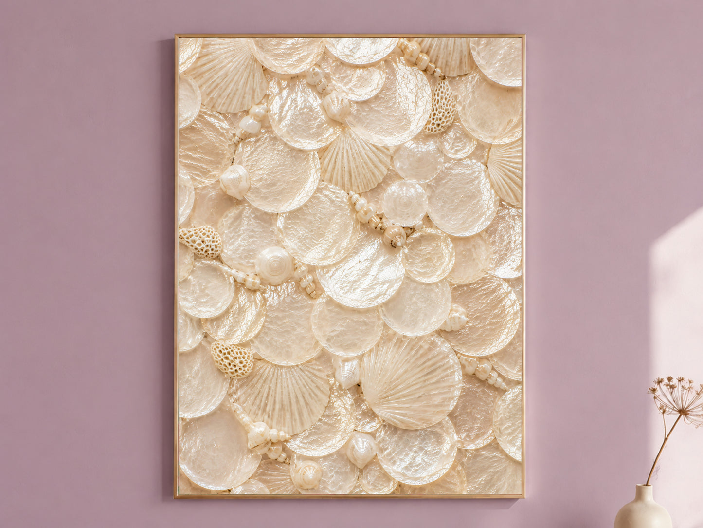 Nautilus shell wall art in a thin gold frame hanging on a dusty mauve wall, styled with a small dried flower vase.