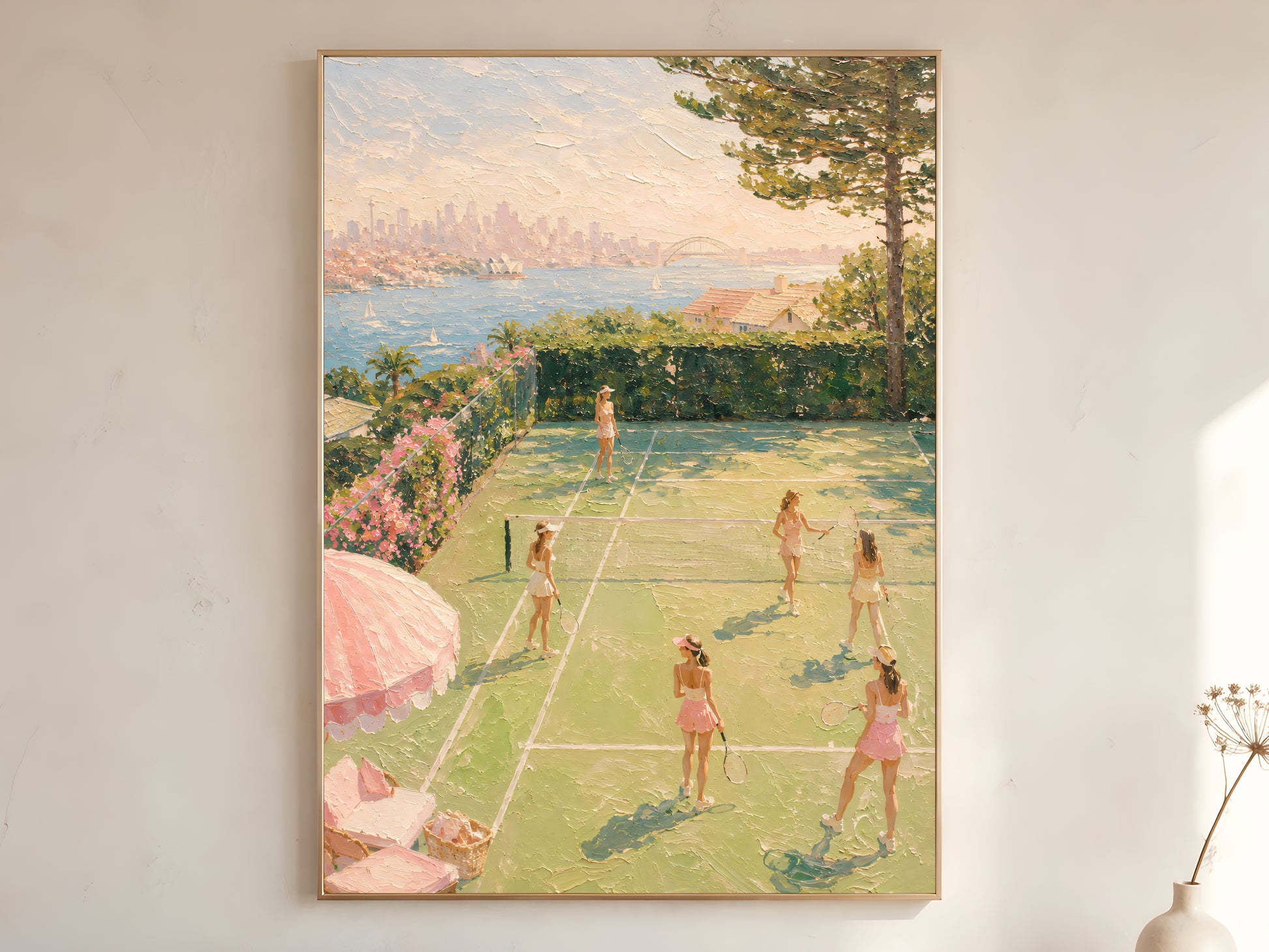Pink tennis court oil painting in gold frame leaning against a white wall with dried florals and harbour view