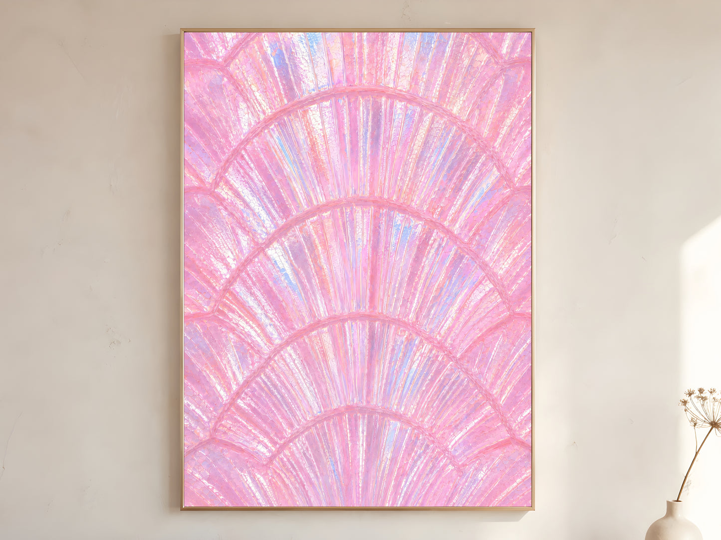 Pink iridescent capiz shell print in gold frame leaning against a white wall with dried florals