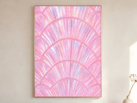 Pink iridescent capiz shell print in gold frame leaning against a white wall with dried florals