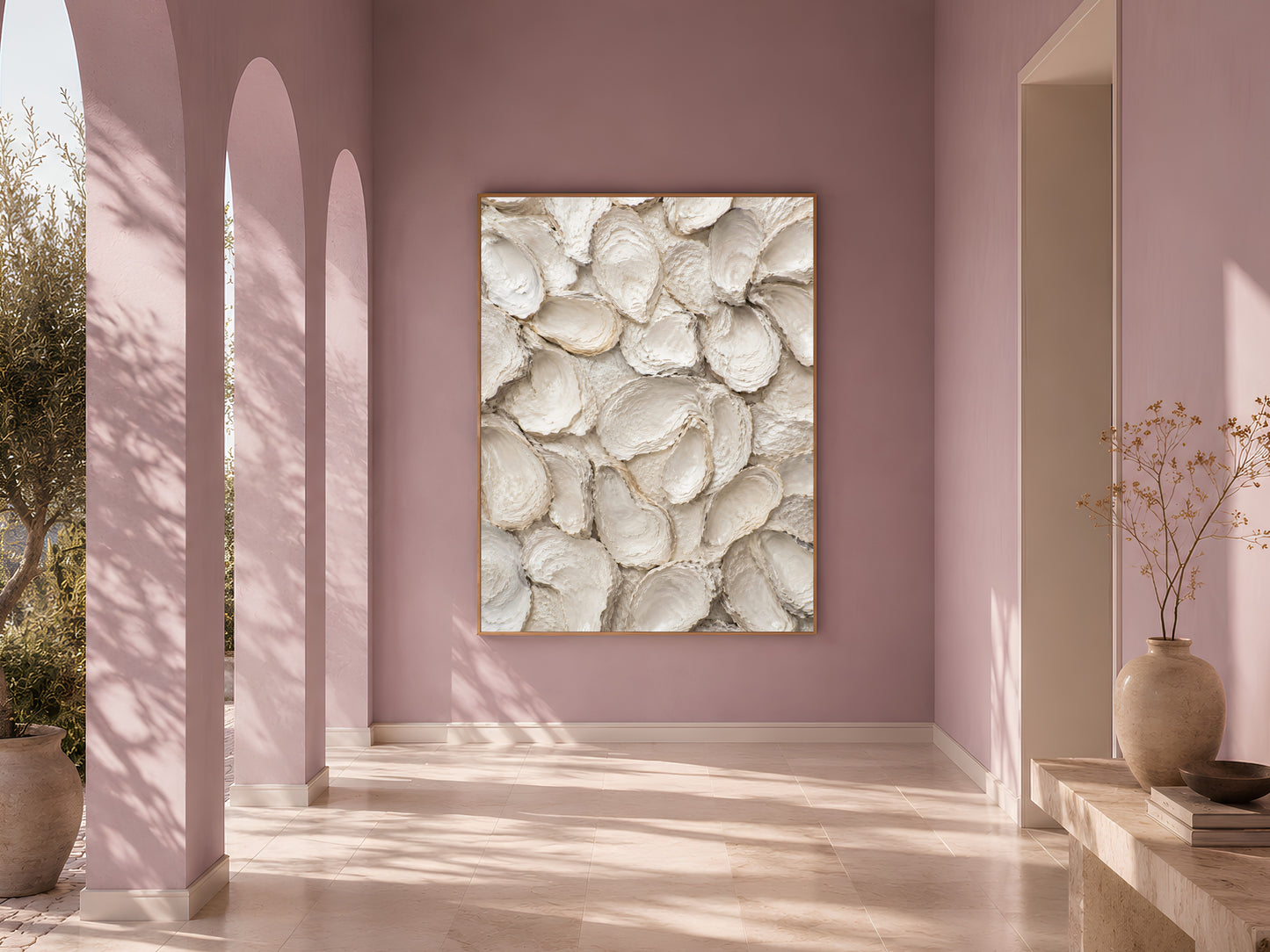 Sunlit arched hallway with dusty mauve walls and a framed whitewashed oyster shell print as a statement piece.